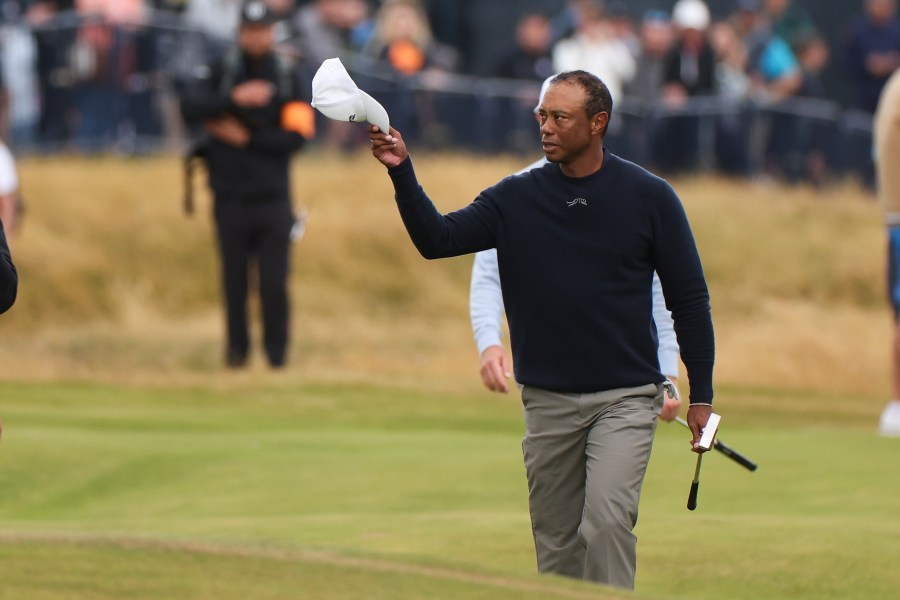 Tiger Woods of the United States waves as he walks to the 18th green during his second round of the British Open Golf Championships at Royal Troon golf club in Troon, Scotland, Friday, July 19, 2024. (AP Photo/Scott Heppell)