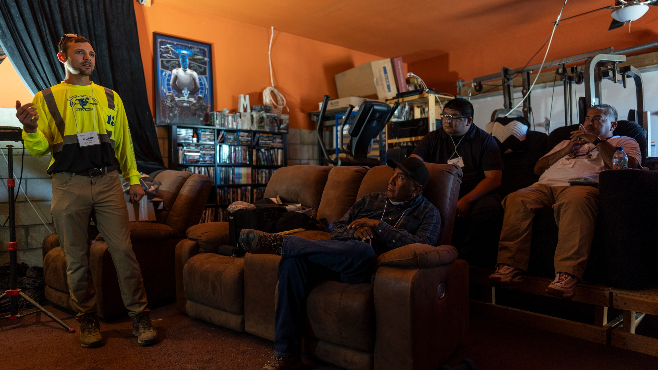 Sitting on recliners in a home movie theater of co-founder Matthew Rantanen's ranch, attendees listen to instructor Dustin LaPointe, left, during the Tribal Broadband Bootcamp in Aguanga, Calif., Wednesday, June 19, 2024. (AP Photo/Jae C. Hong)