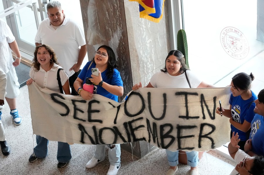 FILE Opponents to an immigration proposal gather inside the Arizona State Capitol, Tuesday, June 4, 2024, in Phoenix. Immigrant advocacy groups this week appealed a judge's ruling to allow the proposal to allow local law enforcement to arrest migrants who cross illegally from Mexico into Arizona between ports of entry to stay on the state's Nov. 5 ballot. (AP Photo/Matt York, File)