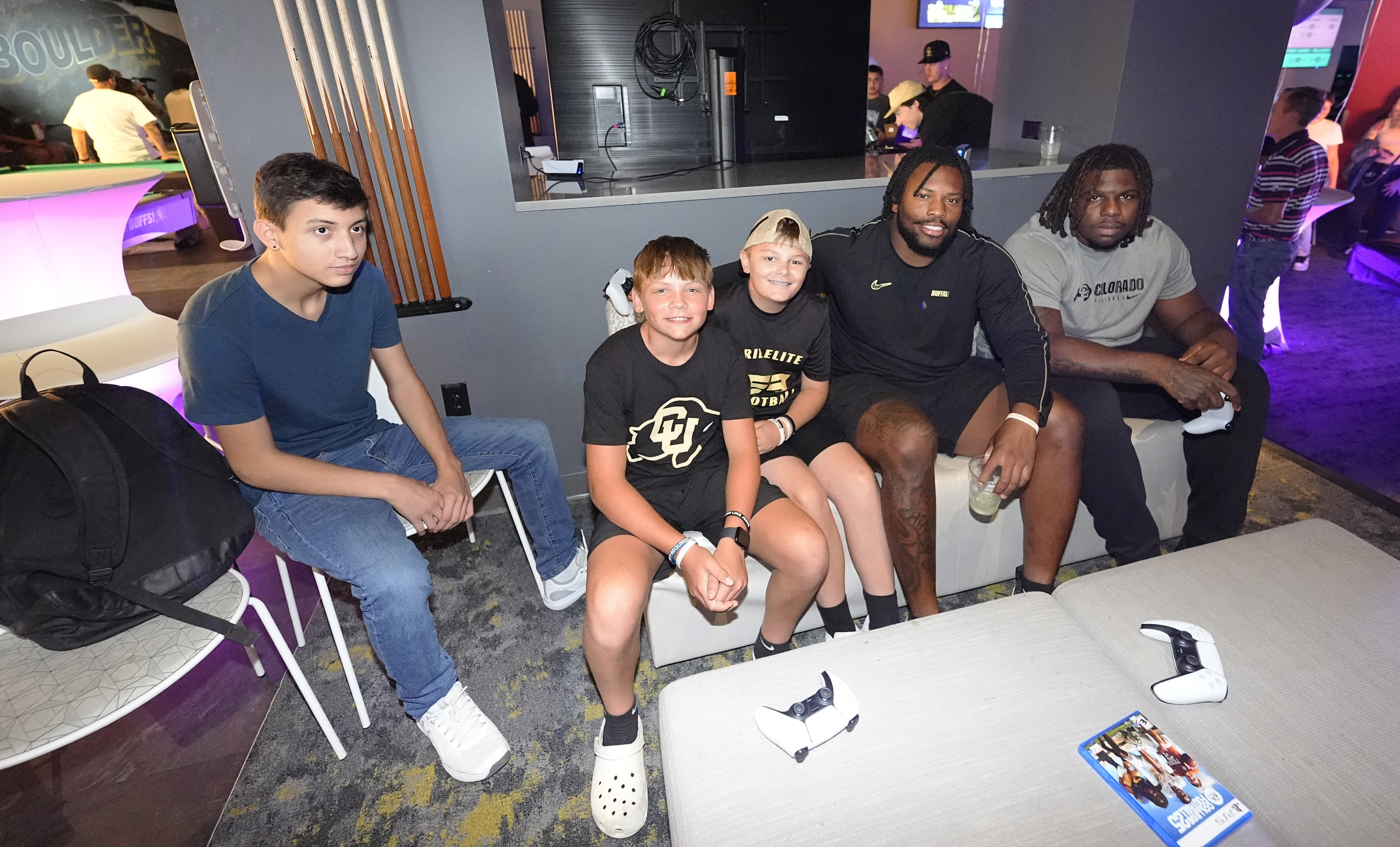 From left to right, Jayden Valdez, of Las Vegas, accompanies Abram Wilkerson and Braylee Bryant, both of Thornton, Colo., in joining Colorado center Yakiri Walker and offensive tackle Kareem Harden to play the EA Sports College Football 25 video game during a release party Friday, July 19, 2024, at the Memorial Union on the campus of the University of Colorado in Boulder, Colo. (AP Photo/David Zalubowski)