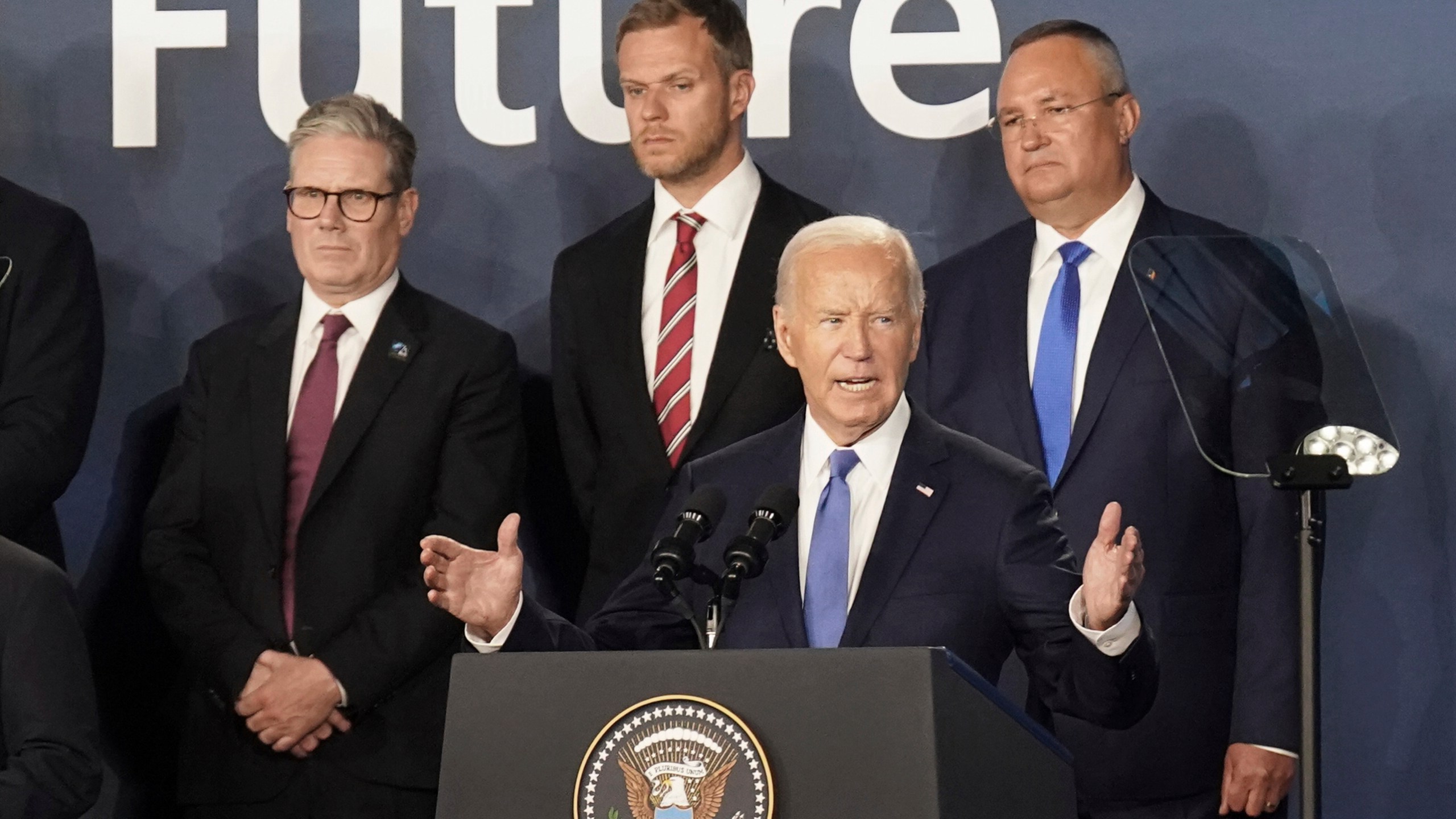 FILE - Britain's Prime Minister Keir Starmer, left, looks on as U.S. President Joe Biden speaks, where he introduced Ukrainian President Volodymyr Zelenskyy during an event on the Ukraine Compact at the NATO Summit at the Walter E. Washington Convention Center, in Washington, Thursday, July 11, 2024. Biden's withdrawal from the U.S. presidential race injects greater uncertainty into the world. (Stefan Rousseau/Pool Photo via AP, File)