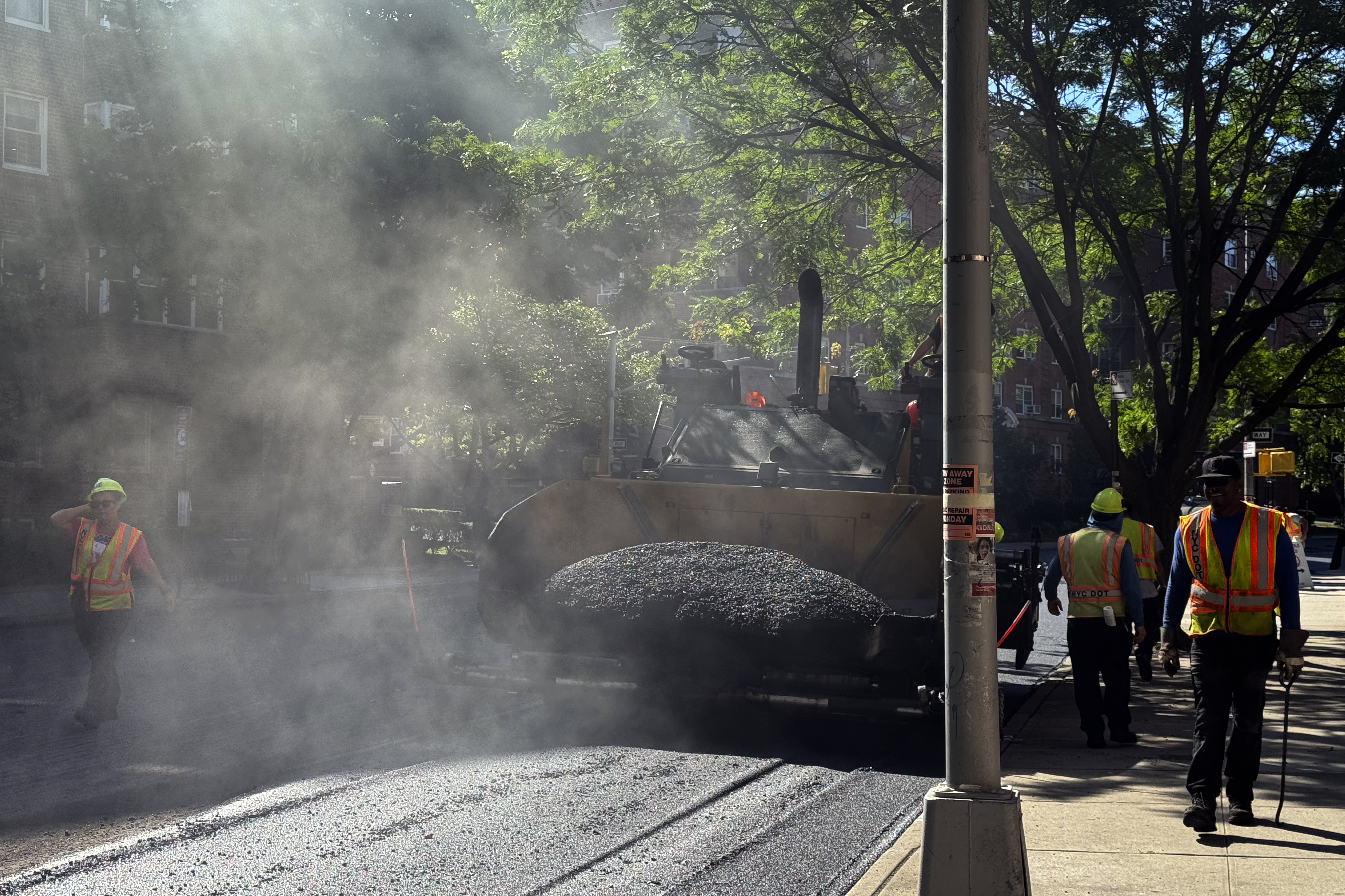 A road crew repaves a road in the Forest Hills neighborhood in the Queens borough of New York, Monday, July 1, 2024. As areas across the U.S. continue to experience extreme heat, employers have taken steps to protect workers from high temperatures. (AP Photo/Daniel P. Derella)
