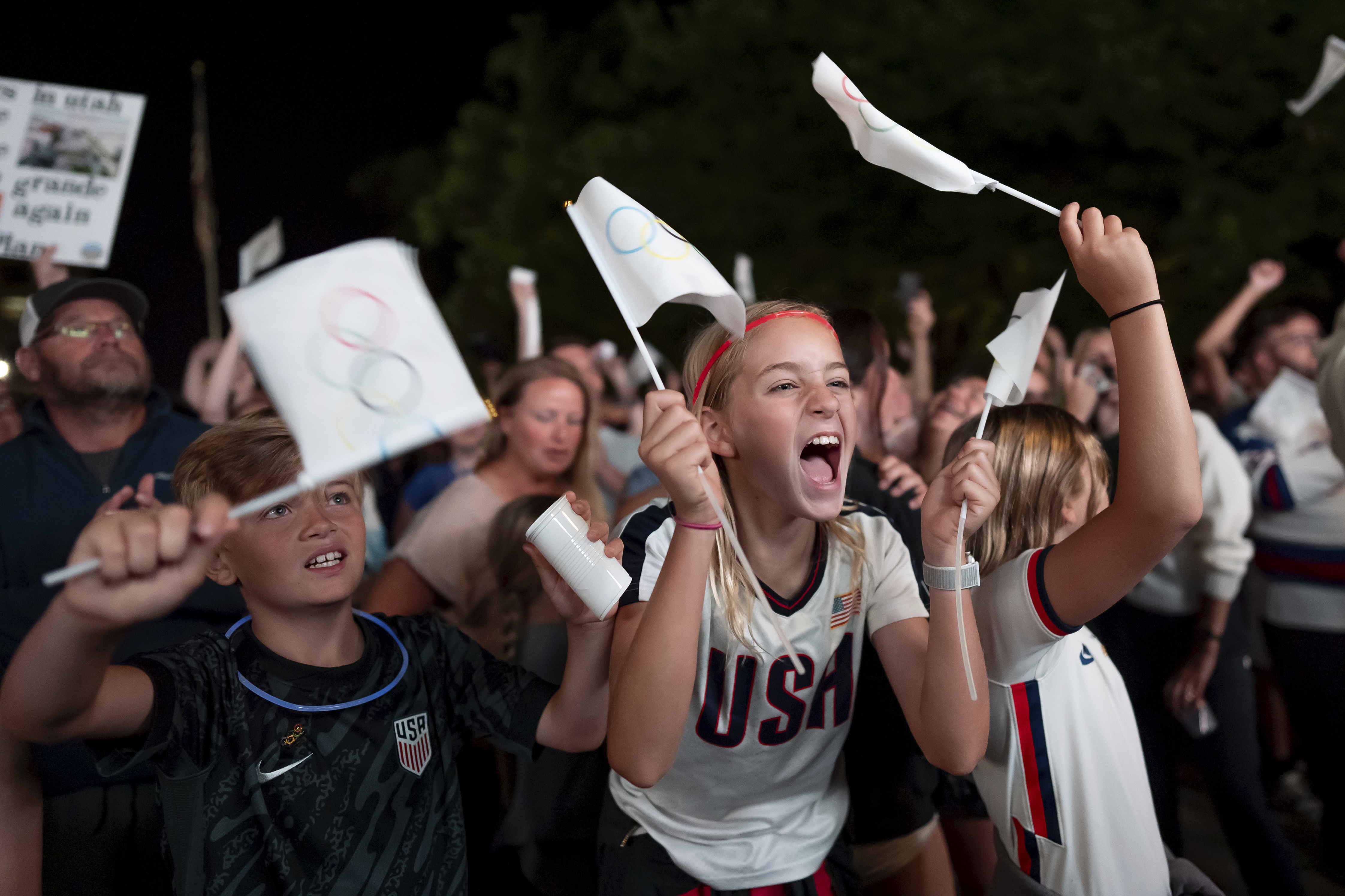 People celebrate while watching a live feed from Paris moments after the International Olympic Committee awarded Salt Lake City the 2034 Winter Olympics, Wednesday, July 24, 2024, in Salt Lake City. (AP Photo/Spenser Heaps)