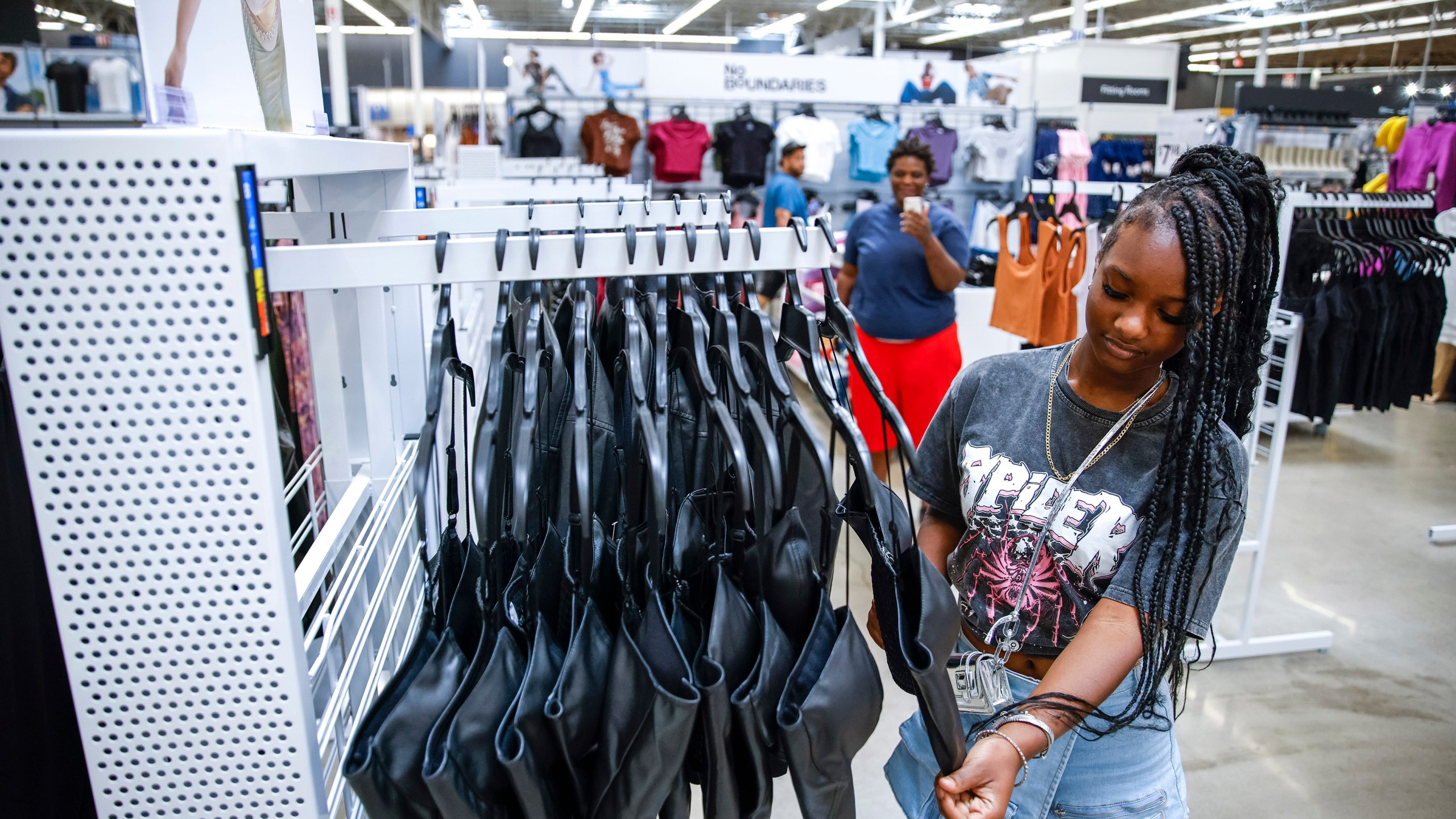 Za'kyra Davis looks at items from Walmart's No Boundaries brand at a Walmart Superstore in Secaucus, New Jersey, Thursday, July 11, 2024. Walmart relaunched No Boundaries, its 30-year-old brand for teenagers and young adults, earlier this month with a new 130-piece fall collection. (AP Photo/Eduardo Munoz Alvarez)