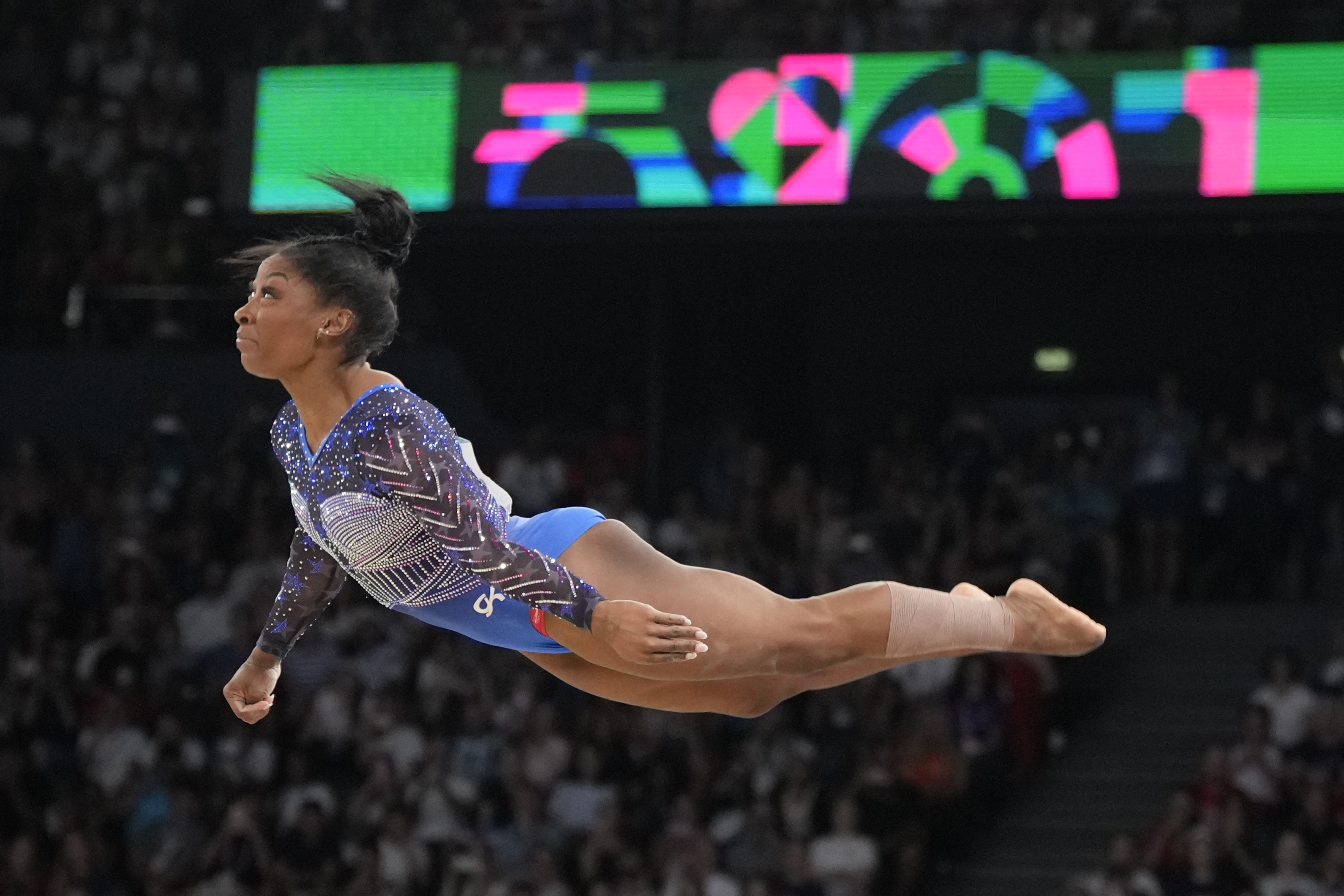 Simone Biles, of the United States, performs on the floor during the women's artistic gymnastics all-around finals in Bercy Arena at the 2024 Summer Olympics, Thursday, Aug. 1, 2024, in Paris, France. (AP Photo/Charlie Riedel)