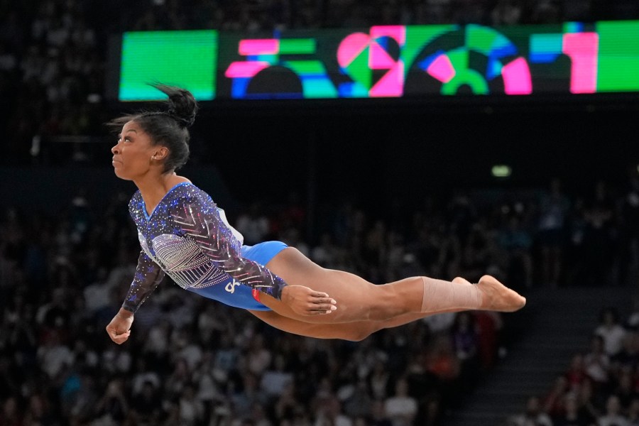 Simone Biles, of the United States, performs on the floor during the women's artistic gymnastics all-around finals in Bercy Arena at the 2024 Summer Olympics, Thursday, Aug. 1, 2024, in Paris, France. (AP Photo/Charlie Riedel)