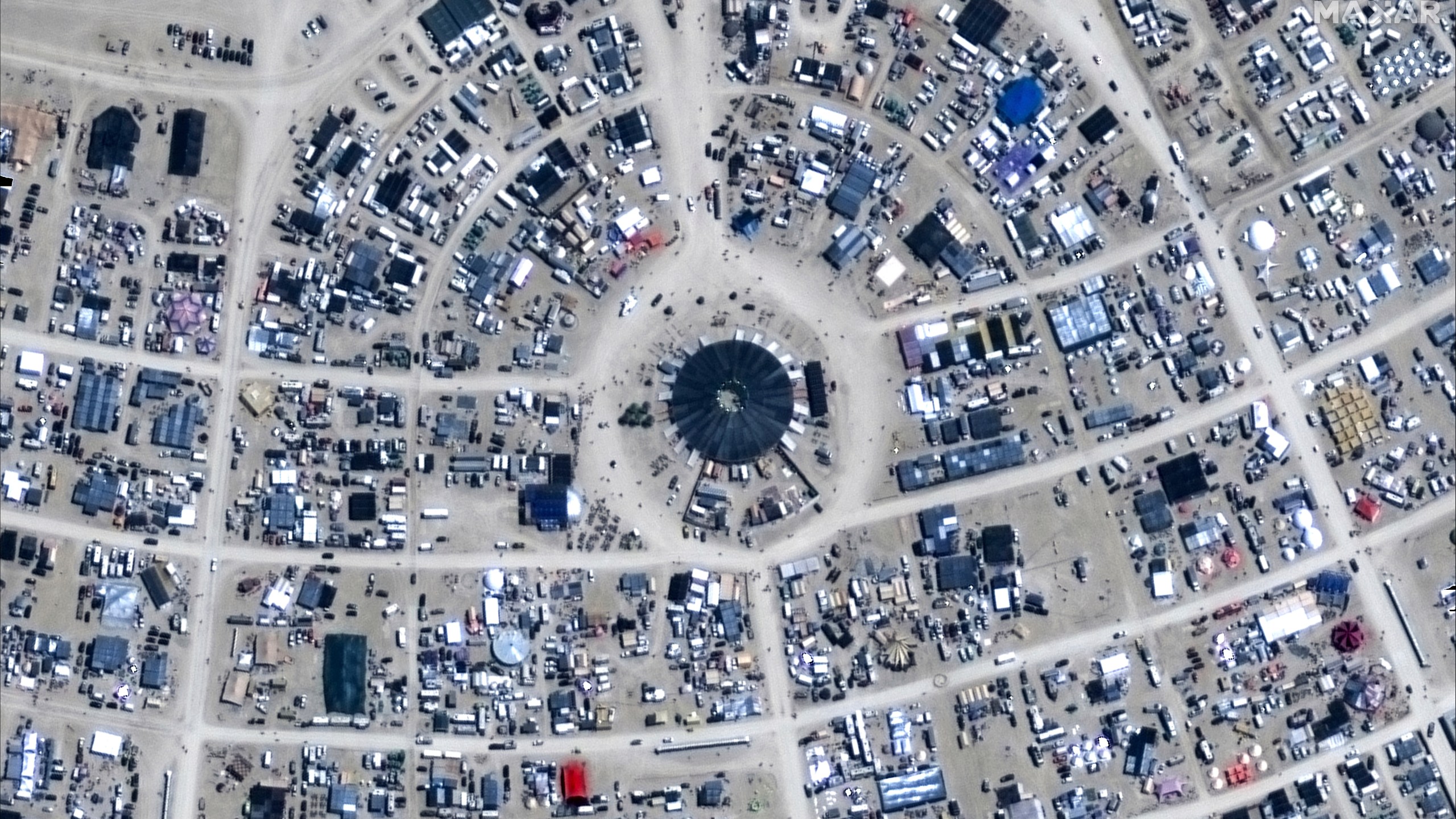 This image released by Maxar Technologies shows an overview of the center camp of the Burning Man 2024 festival, Sunday, Aug. 25, 2024, in Black Rock City, Nev. (Satellite image ©2024 Maxar Technologies via AP)