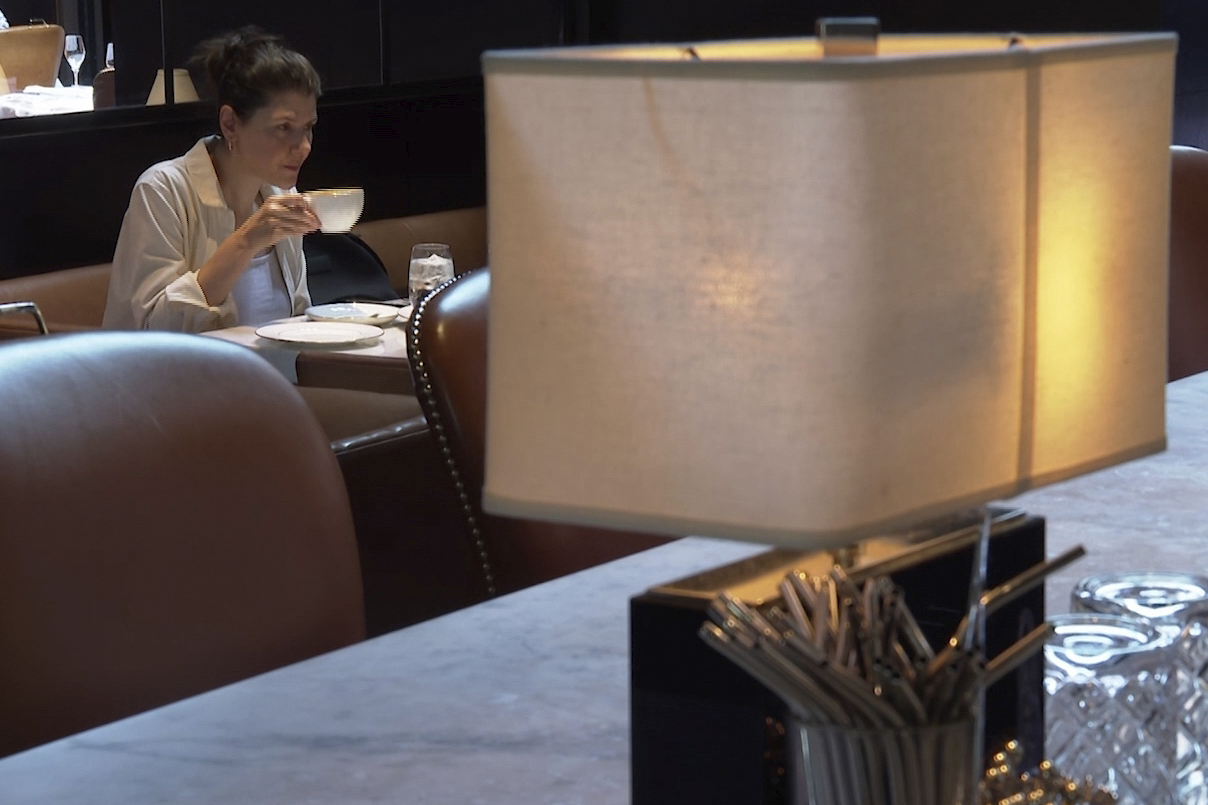 Parisa Imanirad, a scientist and cancer researcher, eats lunch alone at Spruce, an upscale restaurant in San Francisco, on Thursday, Aug. 22, 2024. (AP Photo/Haven Daley)