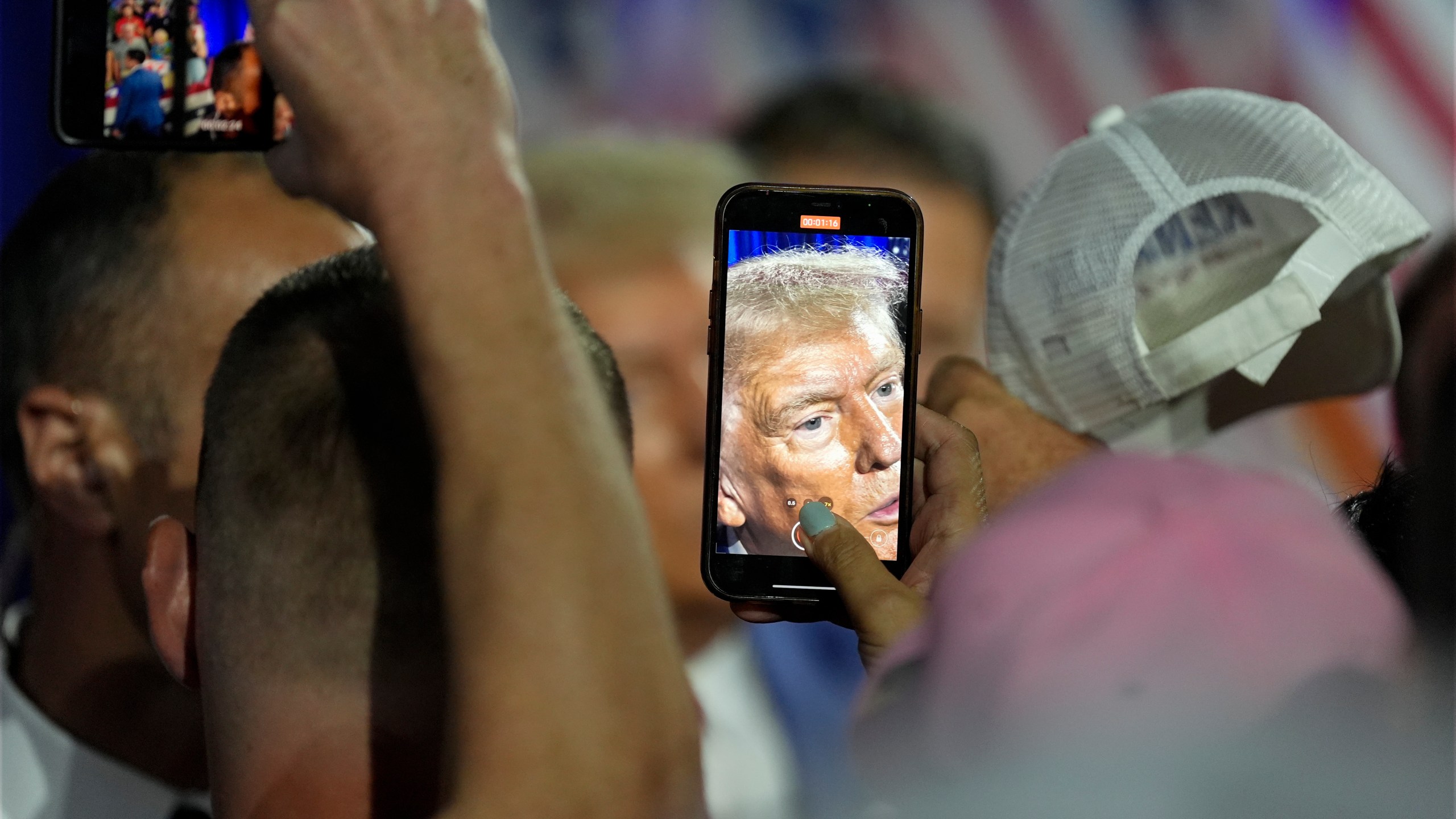 Republican presidential nominee former President Donald Trump greets supporters at a town hall with former Democratic Rep. Tulsi Gabbard, Thursday, Aug. 29, 2024, in La Crosse, Wis. (AP Photo/Morry Gash)