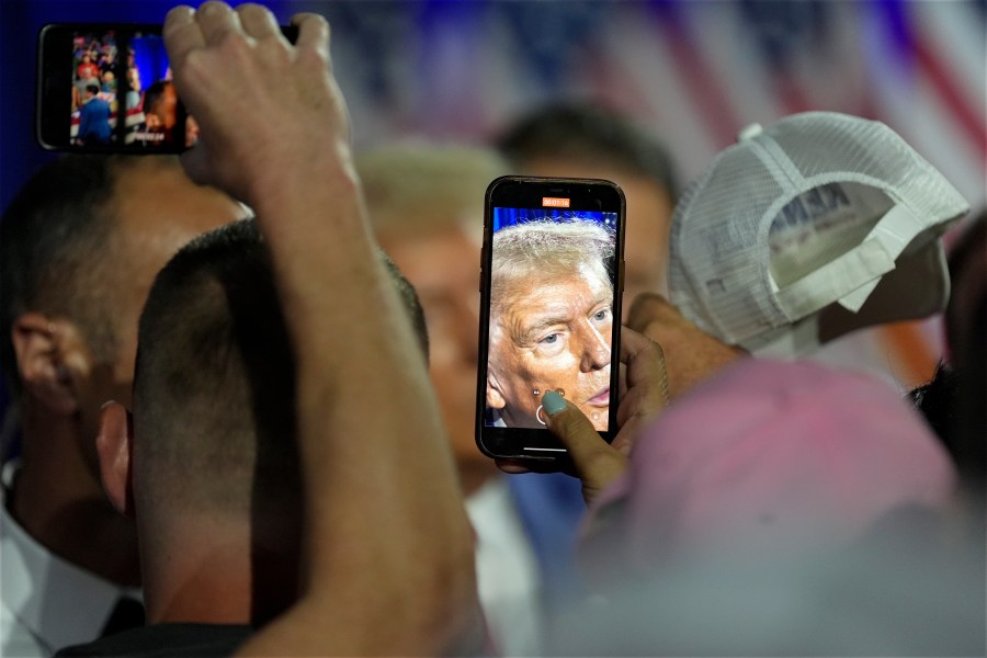 Republican presidential nominee former President Donald Trump greets supporters at a town hall with former Democratic Rep. Tulsi Gabbard, Thursday, Aug. 29, 2024, in La Crosse, Wis. (AP Photo/Morry Gash)