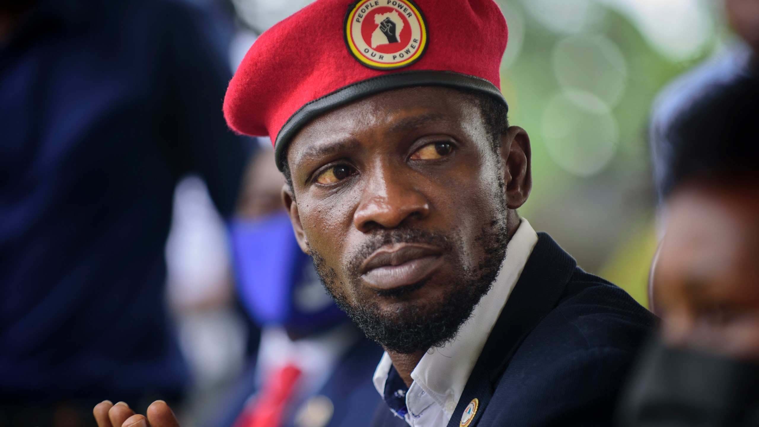 FILE - Opposition presidential challenger Bobi Wine, speaks to the media outside his home, in Magere, near Kampala, in Uganda, Jan. 26, 2021. (AP Photo/Nicholas Bamulanzeki, File)