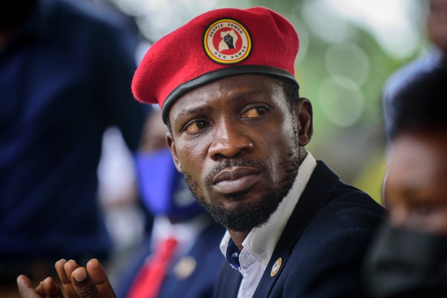 FILE - Opposition presidential challenger Bobi Wine, speaks to the media outside his home, in Magere, near Kampala, in Uganda, Jan. 26, 2021. (AP Photo/Nicholas Bamulanzeki, File)