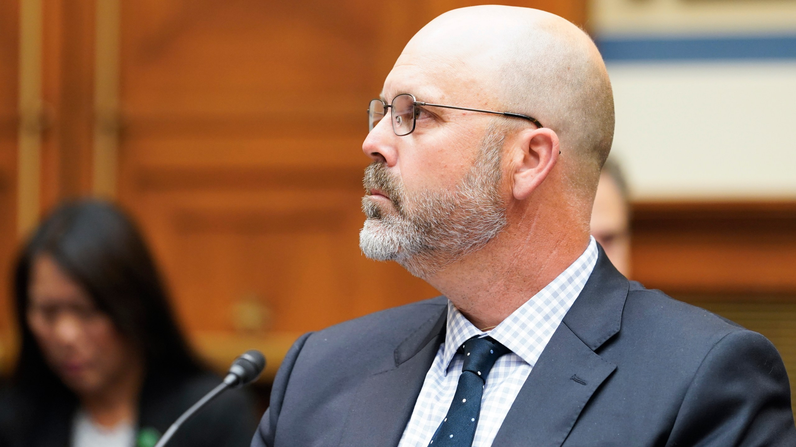 FILE - Ryan Busse, senior advisor at Giffords Law Center, listens during a House Committee on Oversight and Reform hearing, July 27, 2022, on Capitol Hill in Washington. (AP Photo/Mariam Zuhaib, File)