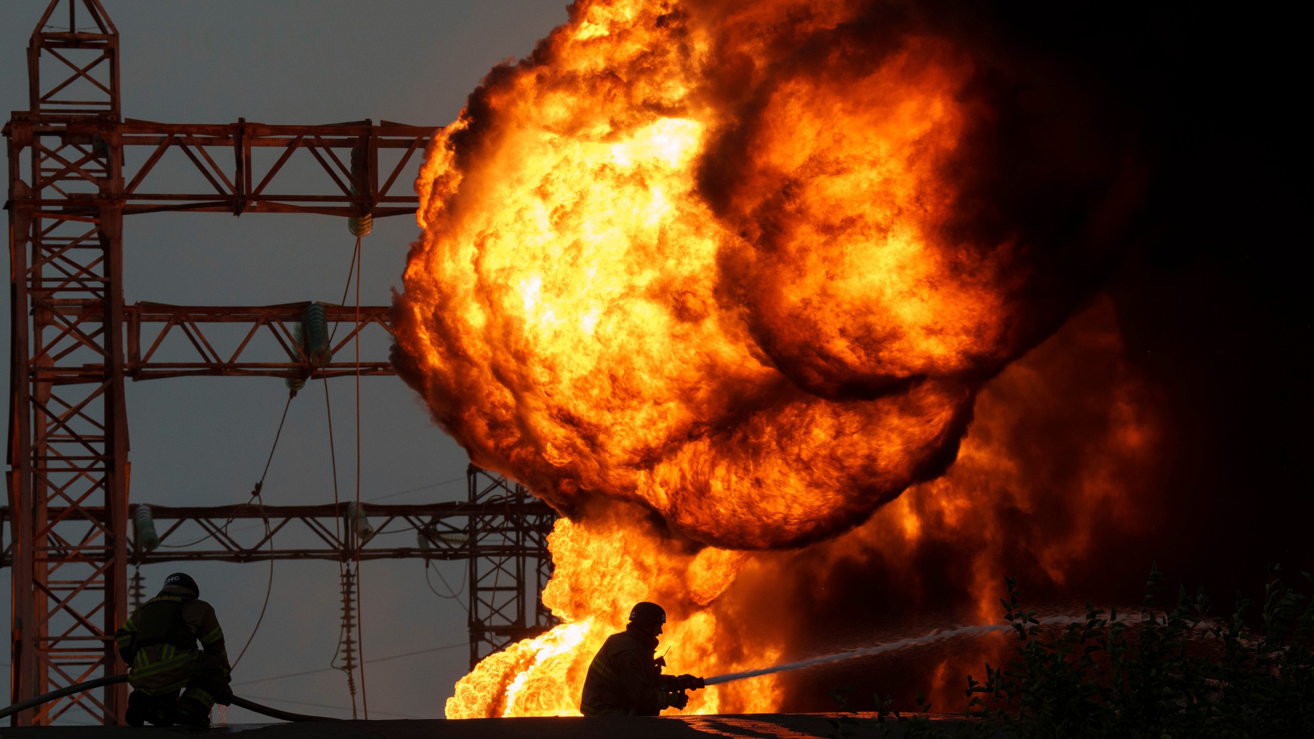 Rescue workers extinguish a fire of a burning electrical substation hit by a Russian bombing in Dnipropetrovsk region, Ukraine, Monday, Sept. 2, 2024. (AP Photo/Evgeniy Maloletka)