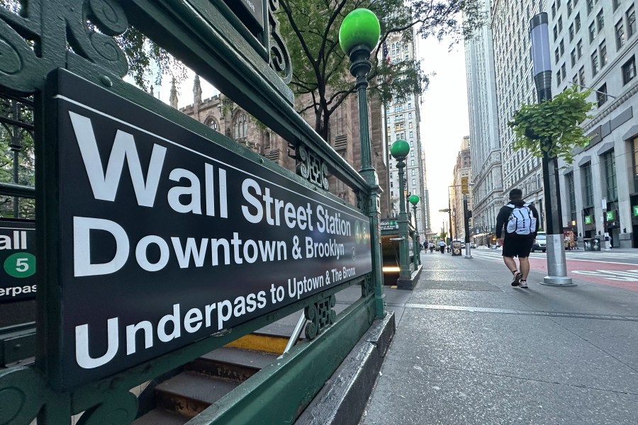 People pass the entrance for the Wall Street subway station on Tuesday, Sept. 2, 2024, in New York. (AP Photo/Peter Morgan)