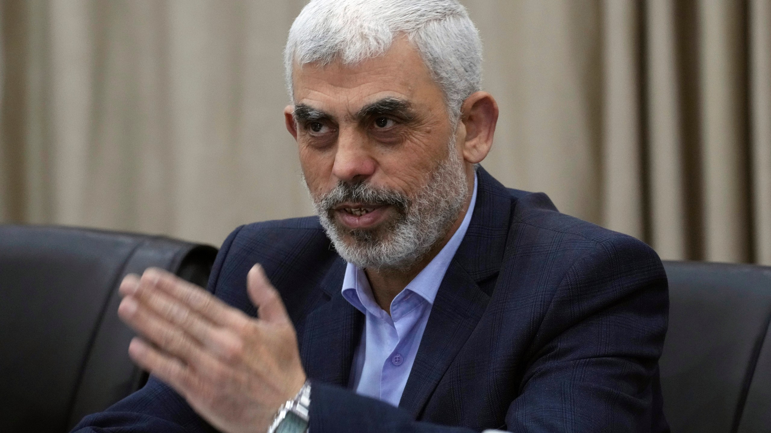 Yahya Sinwar, head of Hamas in Gaza, greets his supporters during a meeting with leaders of Palestinian factions at his office in Gaza City, Wednesday, April 13, 2022. (AP Photo/Adel Hana)