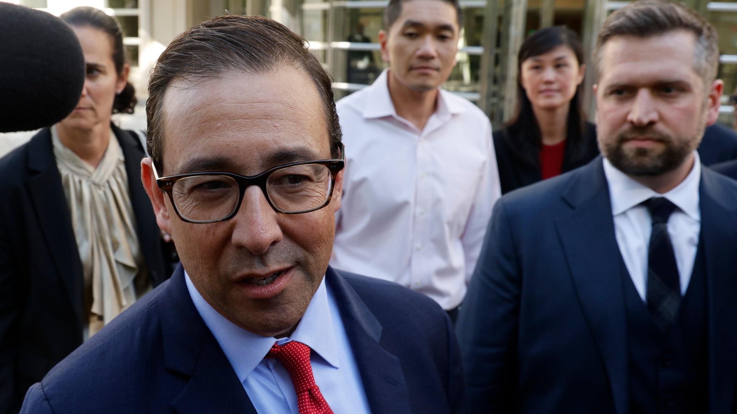 Attorney Seth DuCharme walks in front of former New York Governor Kathy Hochul aide Linda Sun, second from right, and her husband, Christopher Hu, center, as they leave Brooklyn Federal Court after their arraignment, Tuesday, Sept. 3, 2024, in New York. (AP Photo/Corey Sipkin)