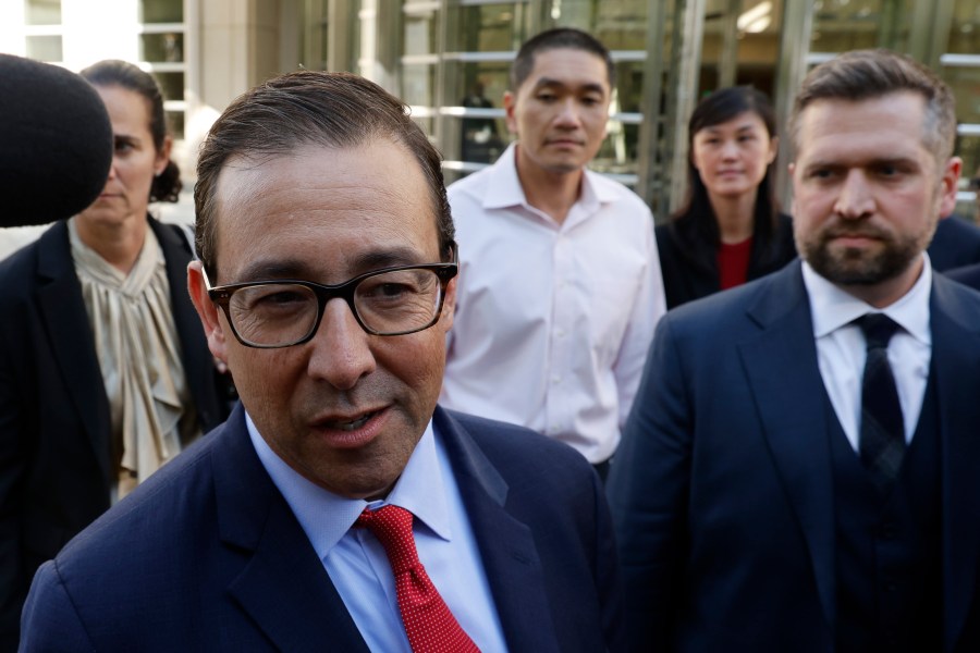 Attorney Seth DuCharme walks in front of former New York Governor Kathy Hochul aide Linda Sun, second from right, and her husband, Christopher Hu, center, as they leave Brooklyn Federal Court after their arraignment, Tuesday, Sept. 3, 2024, in New York. (AP Photo/Corey Sipkin)