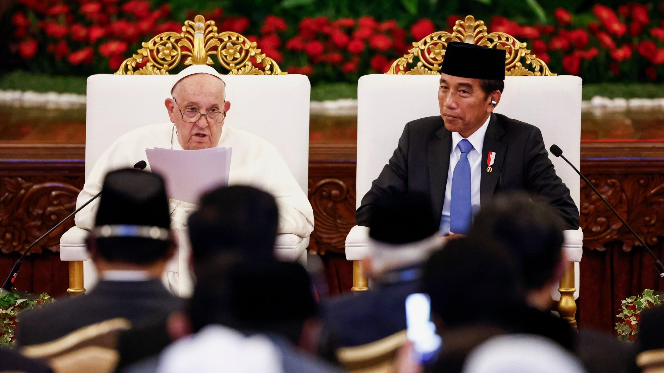 Pope Francis, left, delivers his address as Indonesian President Joko Widodo looks on during a meeting with Indonesian authorities, civil society and the diplomatic corps, during his apostolic visit to Asia, at the Presidential Palace in Jakarta Wednesday, Sept. 4, 2024. (Willy Kurniawan/Pool Photo via AP)