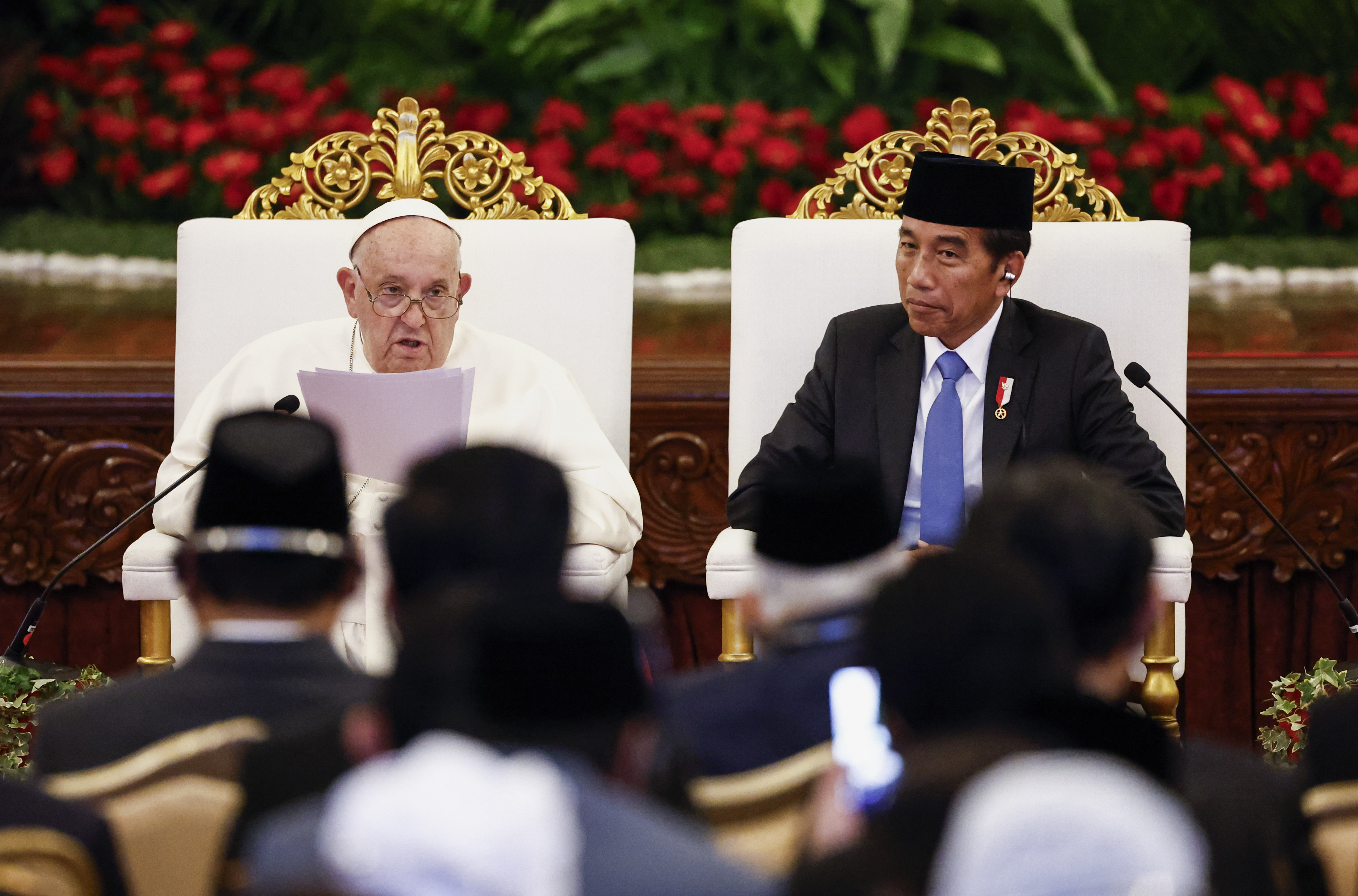 Pope Francis, left, delivers his address as Indonesian President Joko Widodo looks on during a meeting with Indonesian authorities, civil society and the diplomatic corps, during his apostolic visit to Asia, at the Presidential Palace in Jakarta Wednesday, Sept. 4, 2024. (Willy Kurniawan/Pool Photo via AP)