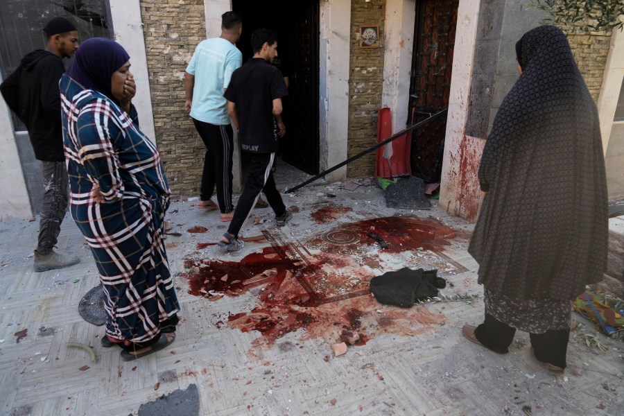 Palestinians look at blood stains at the site of an Israeli army raid where Palestinians say two were killed near Tulkarem, West Bank, Tuesday, Sept. 3, 2024. The dead were not immediately identified, but Israel launched a major offensive in the area last week in an operation it says is aimed against Palestinian militants. (AP Photo/Majdi Mohammed)