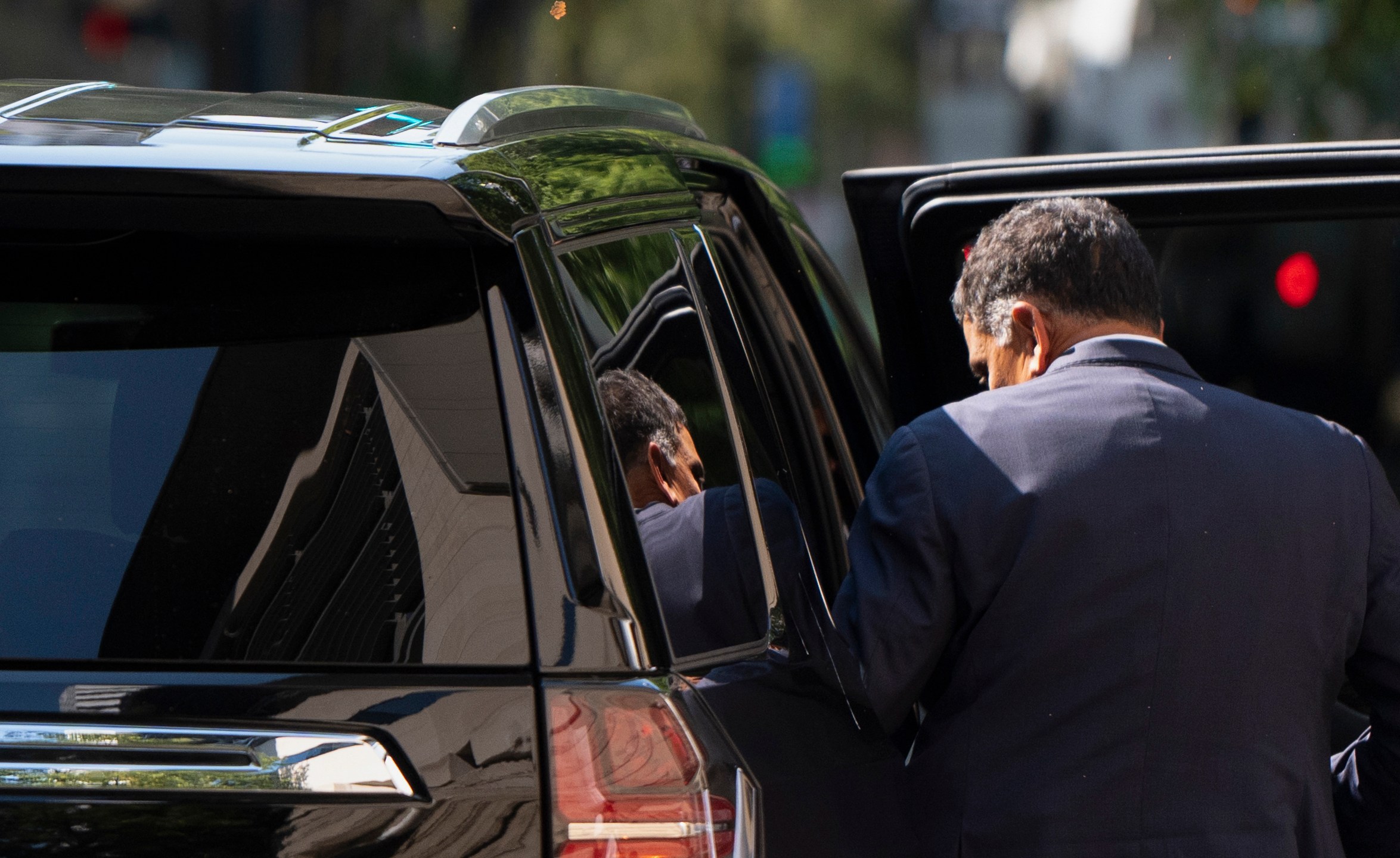 The federal courthouse is reflected in the rear window as Albertsons CEO Vivek Sankaran enters a vehicle and leaves after testifying in a federal court hearing on Wednesday, Sept. 4, 2024, in Portland, Ore. The Federal Trade Commission is seeking a preliminary injunction to block a merger of supermarket companies Albertsons and Kroger. (AP Photo/Jenny Kane)