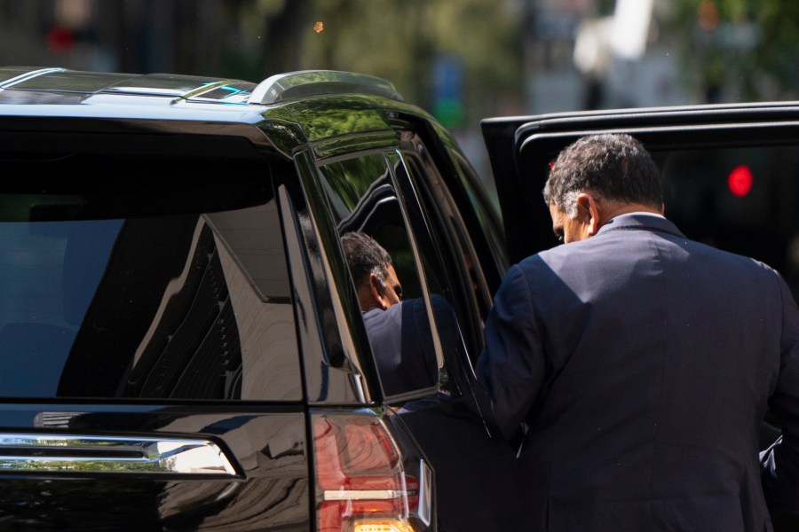 The federal courthouse is reflected in the rear window as Albertsons CEO Vivek Sankaran enters a vehicle and leaves after testifying in a federal court hearing on Wednesday, Sept. 4, 2024, in Portland, Ore. The Federal Trade Commission is seeking a preliminary injunction to block a merger of supermarket companies Albertsons and Kroger. (AP Photo/Jenny Kane)