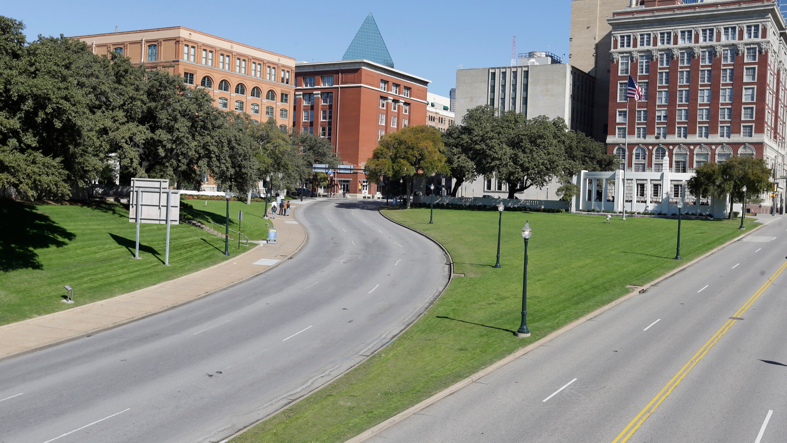 File - In this Nov. 12, 2013 file photo, the former Texas School Book Depository building, left, now known as the Sixth Floor Museum overlooks Dealey Plaza in Dallas, where Lee Harvery Oswald fired from the building killing President John F. Kennedy on Nov. 22, 1963. (AP Photo/LM Otero, File)