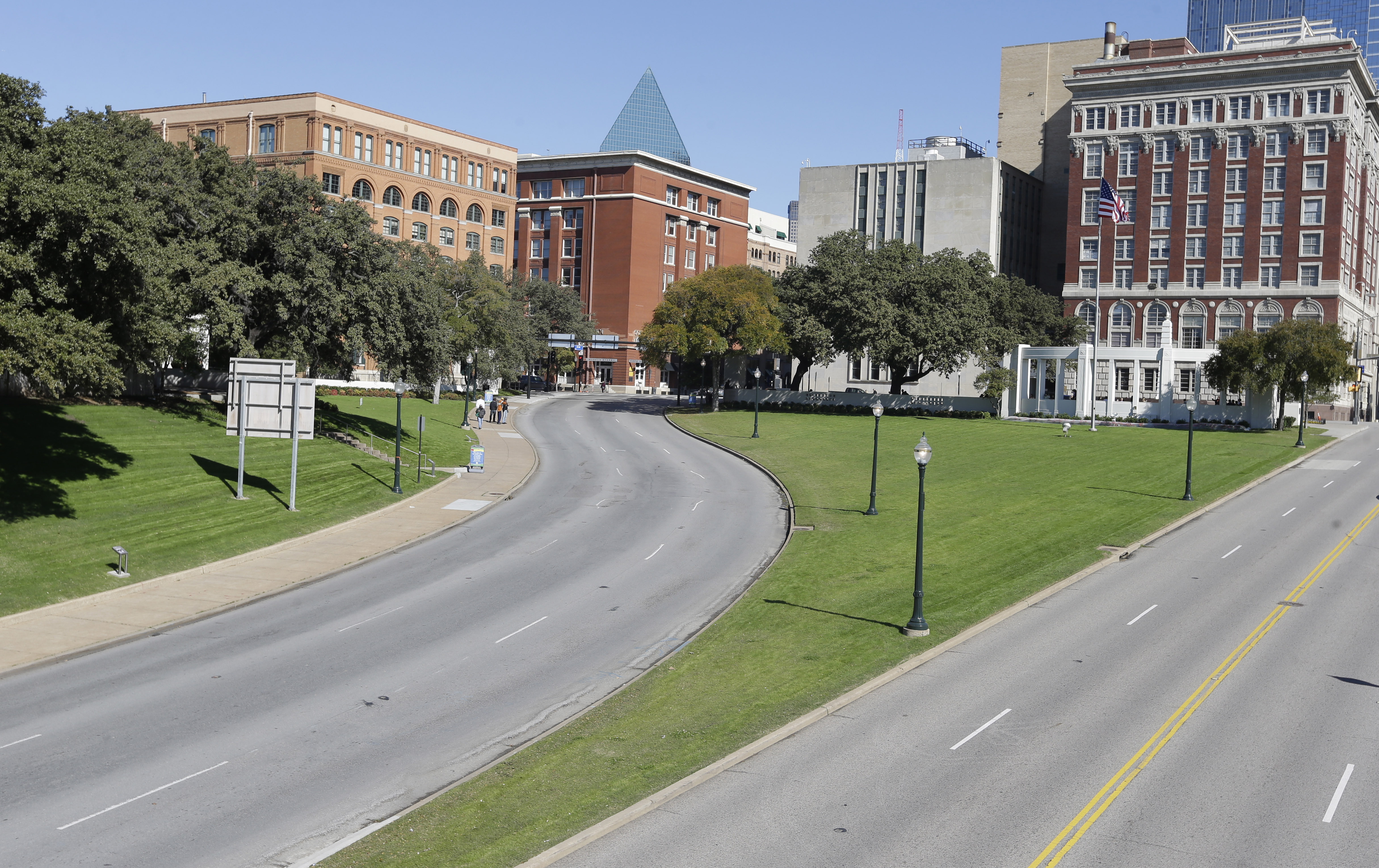 File - In this Nov. 12, 2013 file photo, the former Texas School Book Depository building, left, now known as the Sixth Floor Museum overlooks Dealey Plaza in Dallas, where Lee Harvery Oswald fired from the building killing President John F. Kennedy on Nov. 22, 1963. (AP Photo/LM Otero, File)