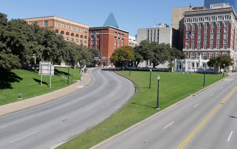 File - In this Nov. 12, 2013 file photo, the former Texas School Book Depository building, left, now known as the Sixth Floor Museum overlooks Dealey Plaza in Dallas, where Lee Harvery Oswald fired from the building killing President John F. Kennedy on Nov. 22, 1963. (AP Photo/LM Otero, File)