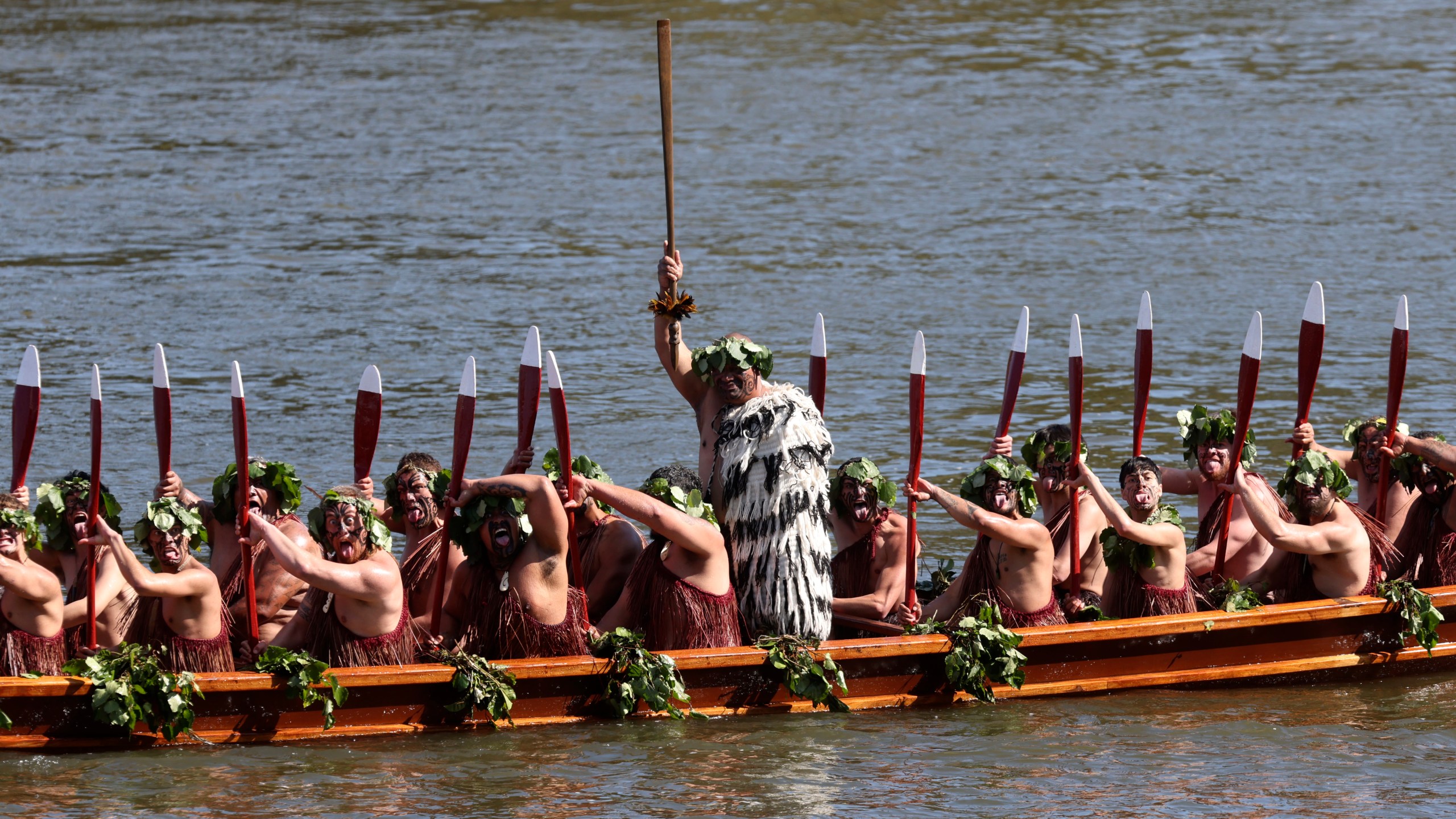 A waka, a traditional canoe, is paddled by warriors as part of the funeral of New Zealand's Maori King, Kiingi Tuheitia Pootatau Te Wherowhero VII, in Ngaruawahia, New Zealand, Thursday, Sept. 5, 2024. (AP Photo/Alan Gibson)