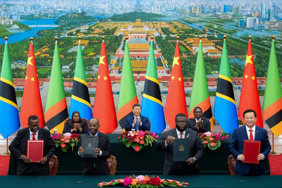 In this photo released by Xinhua News Agency, real from left, Tanzania's President Samia Suluhu Hassan, Chinese President Xi Jinping and Zambia President Hakainde Hichilema applaud as they witness the signing of a memorandum of understanding on the revitalisation project of the Tanzania-Zambia Authority railway, at the Great Hall of the People in Beijing, Wednesday, Sept. 4, 2024, ahead of the China Africa Forum. (Zhai Jianlan/Xinhua via AP)