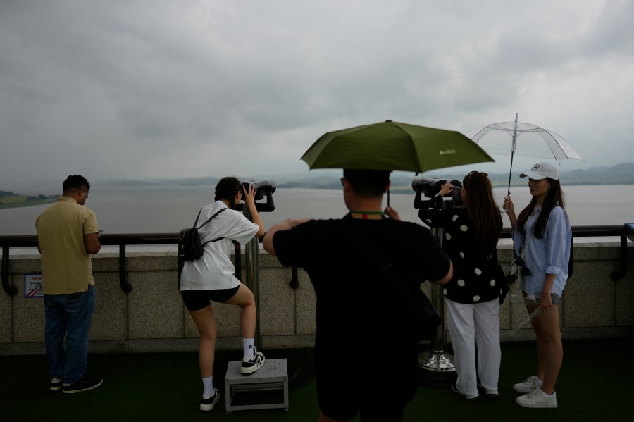 Visitors use binoculars to see the North Korean side from the unification observatory in Paju, South Korea, Thursday, Sept. 5, 2024. (AP Photo/Lee Jin-man)