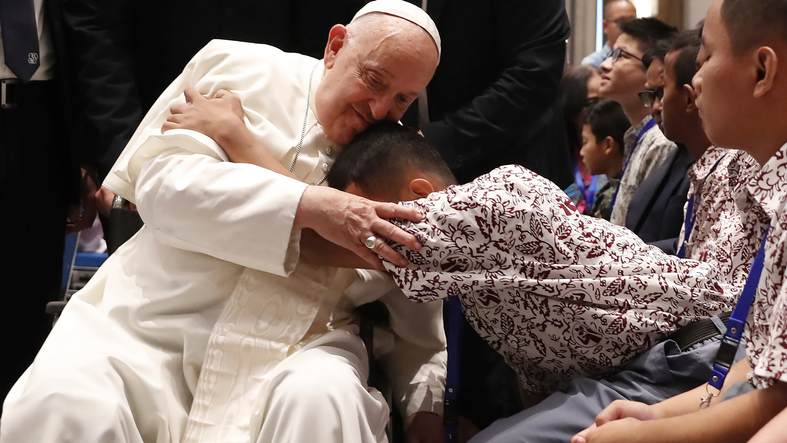 Pope Francis, left, blesses a beneficiary from charitable organizations at the Indonesian Bishops' Conference Headquarters in Jakarta Thursday, Sept. 5, 2024. (Adi Weda/Pool Photo via AP)