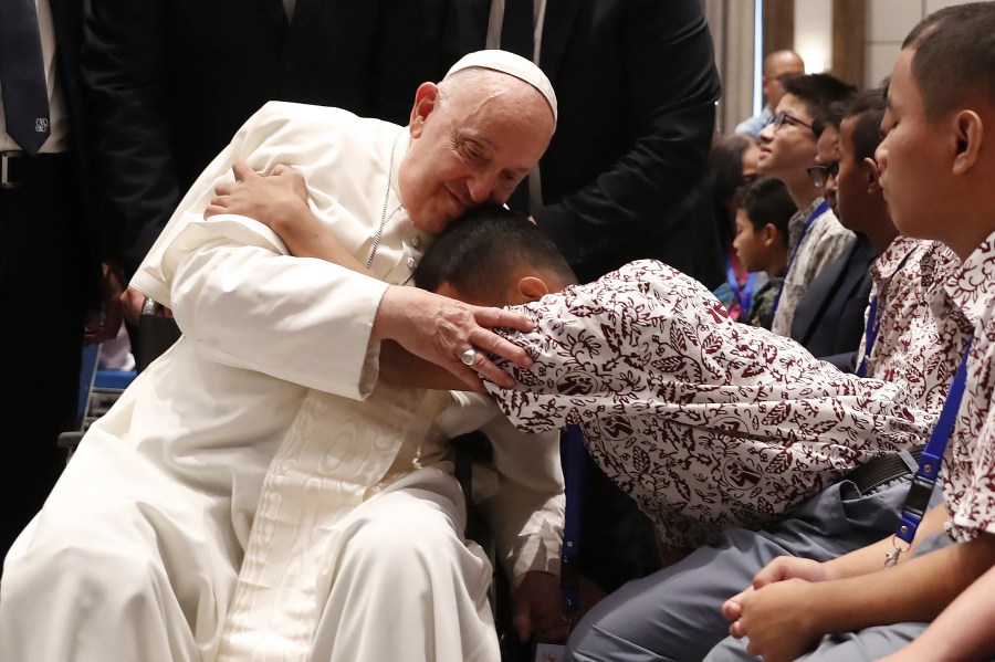 Pope Francis, left, blesses a beneficiary from charitable organizations at the Indonesian Bishops' Conference Headquarters in Jakarta Thursday, Sept. 5, 2024. (Adi Weda/Pool Photo via AP)