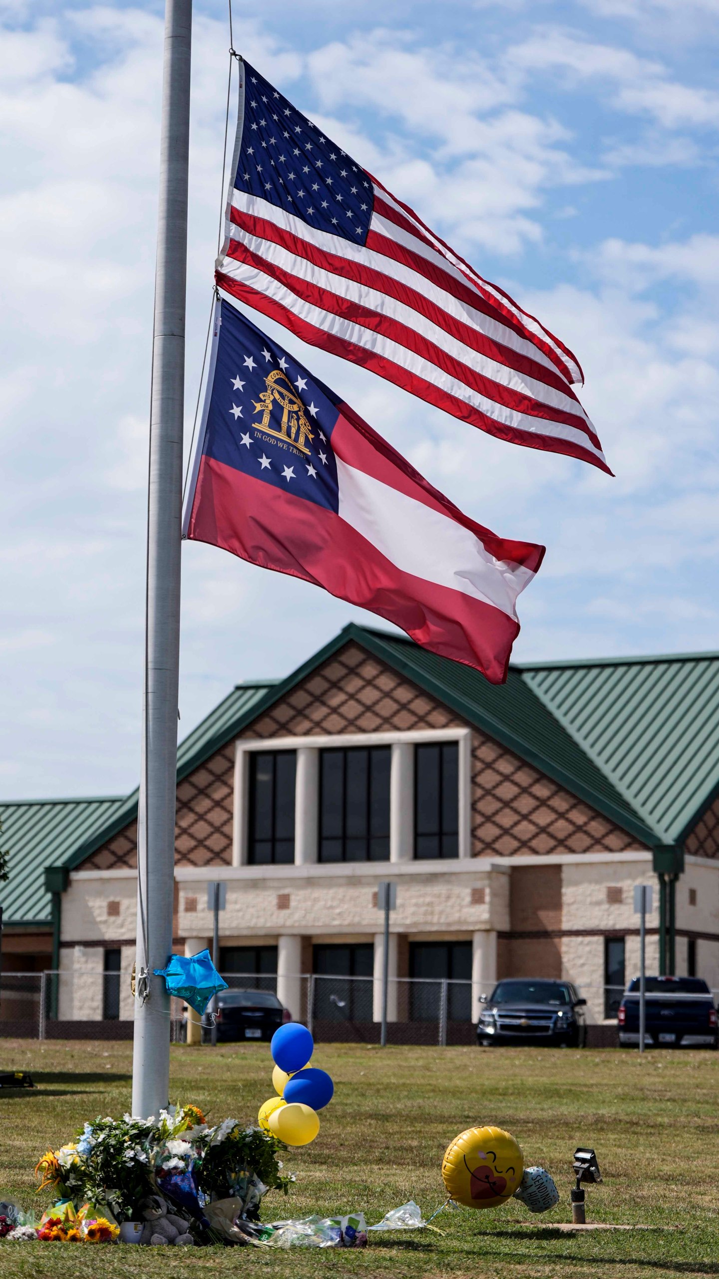 The American and state of Georgia flags fly half-staff after a shooting Wednesday at Apalachee High School, Thursday, Sept. 5, 2024, in Winder, Ga. (AP Photo/Mike Stewart)