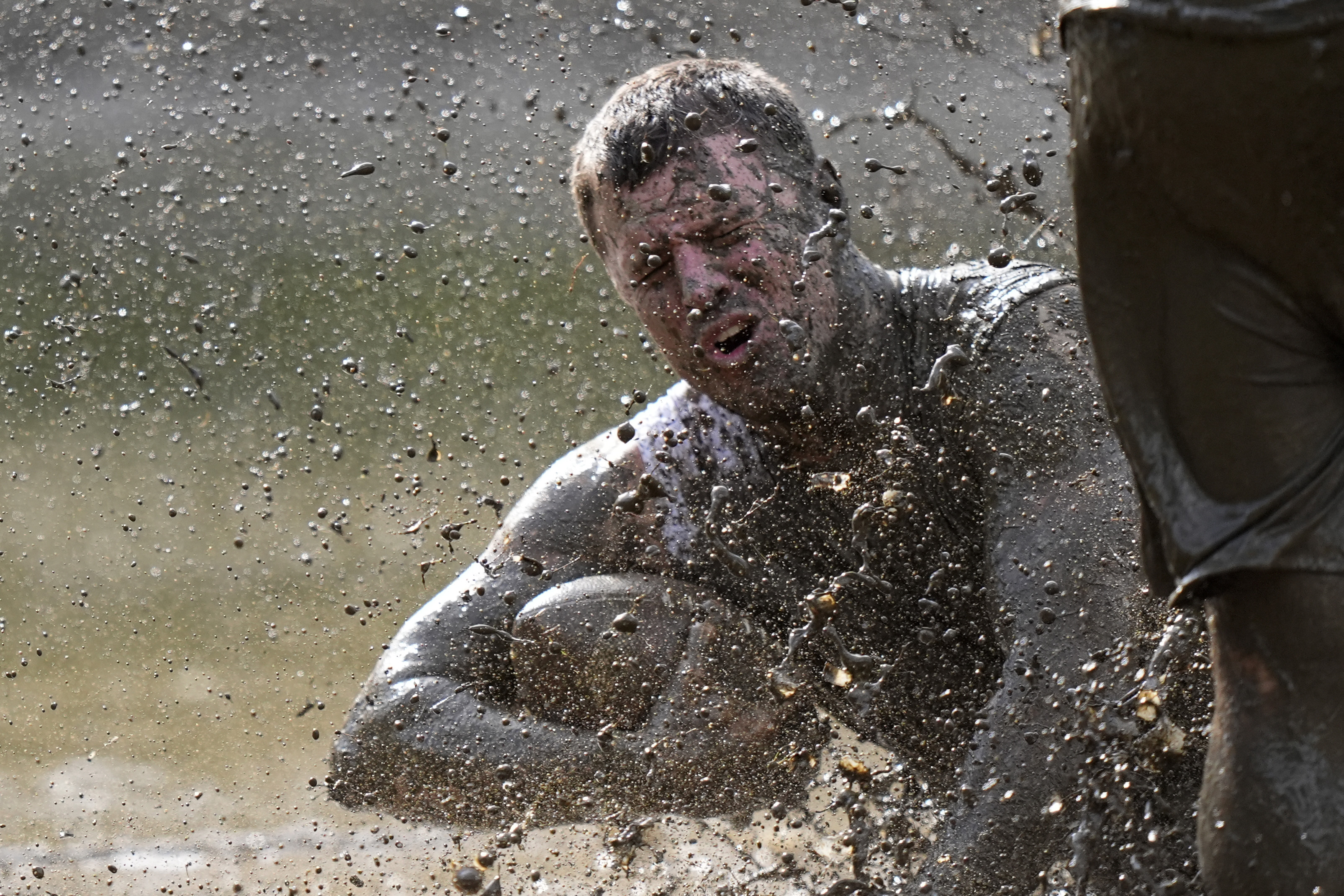 Mike Woodworth, of the the Muddas, goes down after making a catch in a football game at the Mud Bowl in North Conway, N.H., Saturday, Sept. 7, 2024. (AP Photo/Robert F. Bukaty)