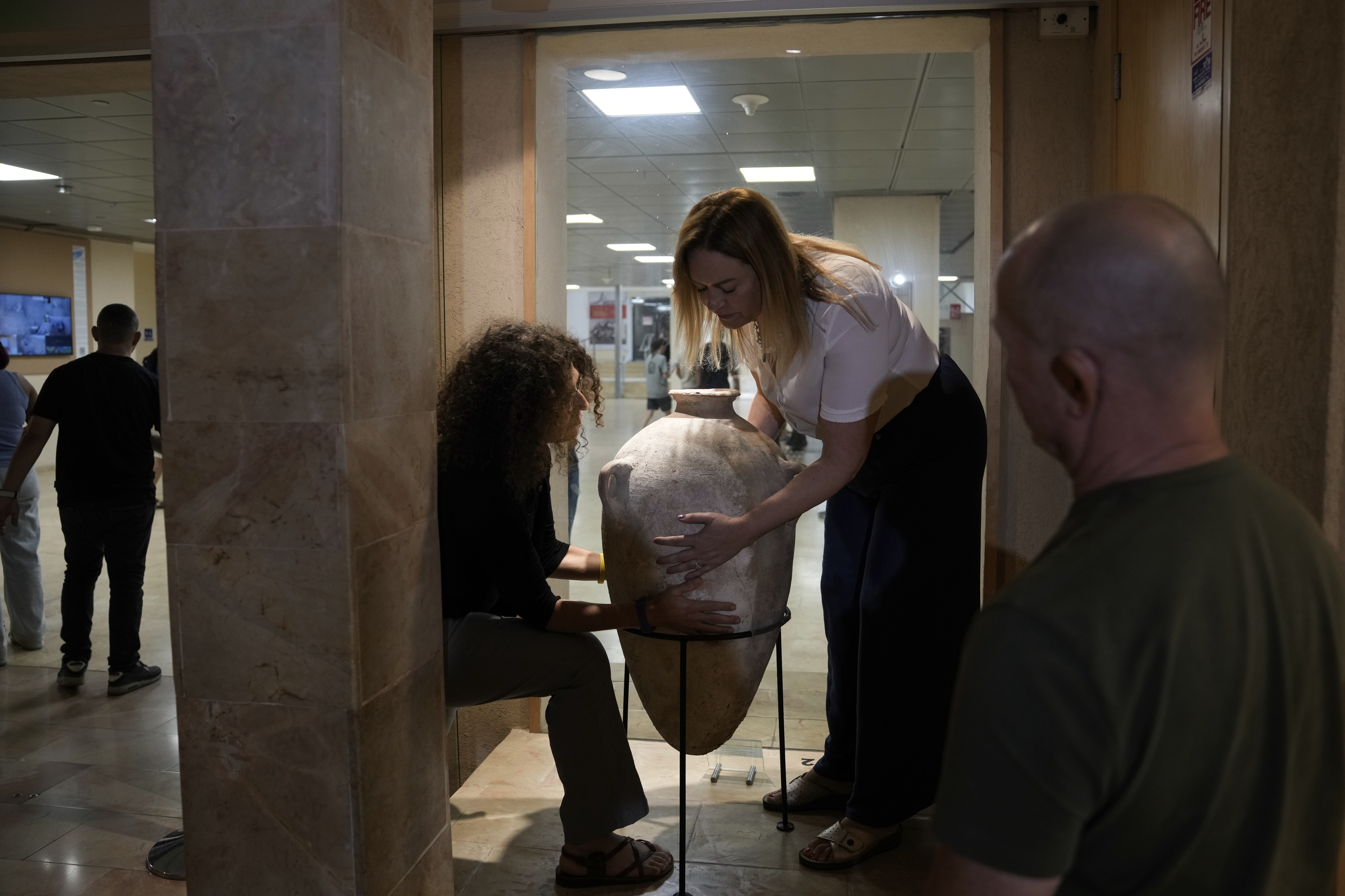 A rare bronze-era jar, newly reassembled, returned to public exhibition after a four-year-old accidentally broke the jar in August during a visit in Hecht Museum of the University of Haifa, Israel, on Wednesday, Sept. 11, 2024. (AP Photo/Mahmoud Illean)