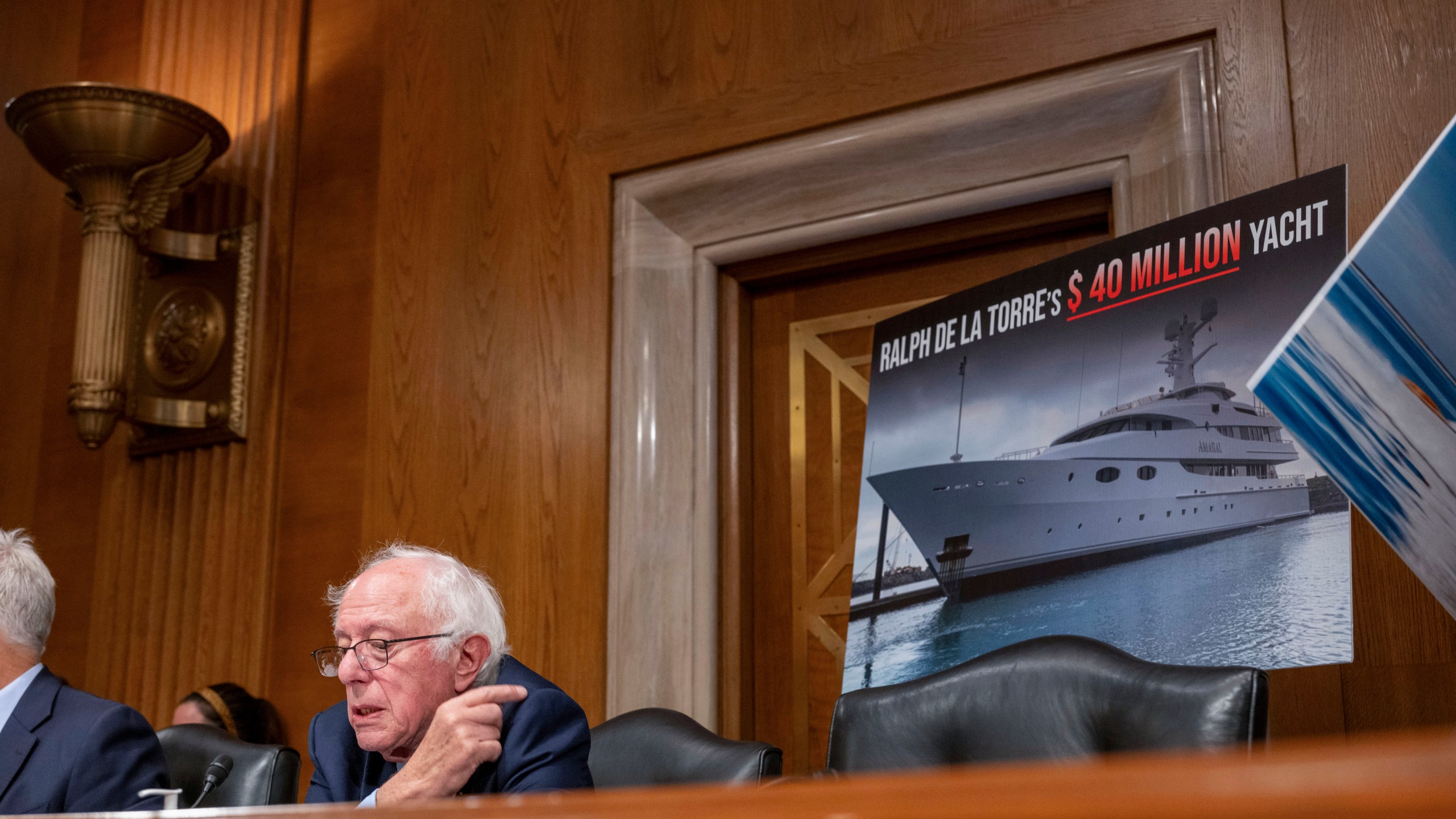 Sen. Bernie Sanders, I-Vt., points to a photo of a yacht owned by Steward Health Care System CEO Ralph de la Torre who failed to show and testify before the Senate Health, Education, Labor, and Pensions hearing to examine the bankruptcy of Steward Health Care on Thursday, Sept. 12, 2024 on Capitol Hill in Washington. (AP Photo/Kevin Wolf)