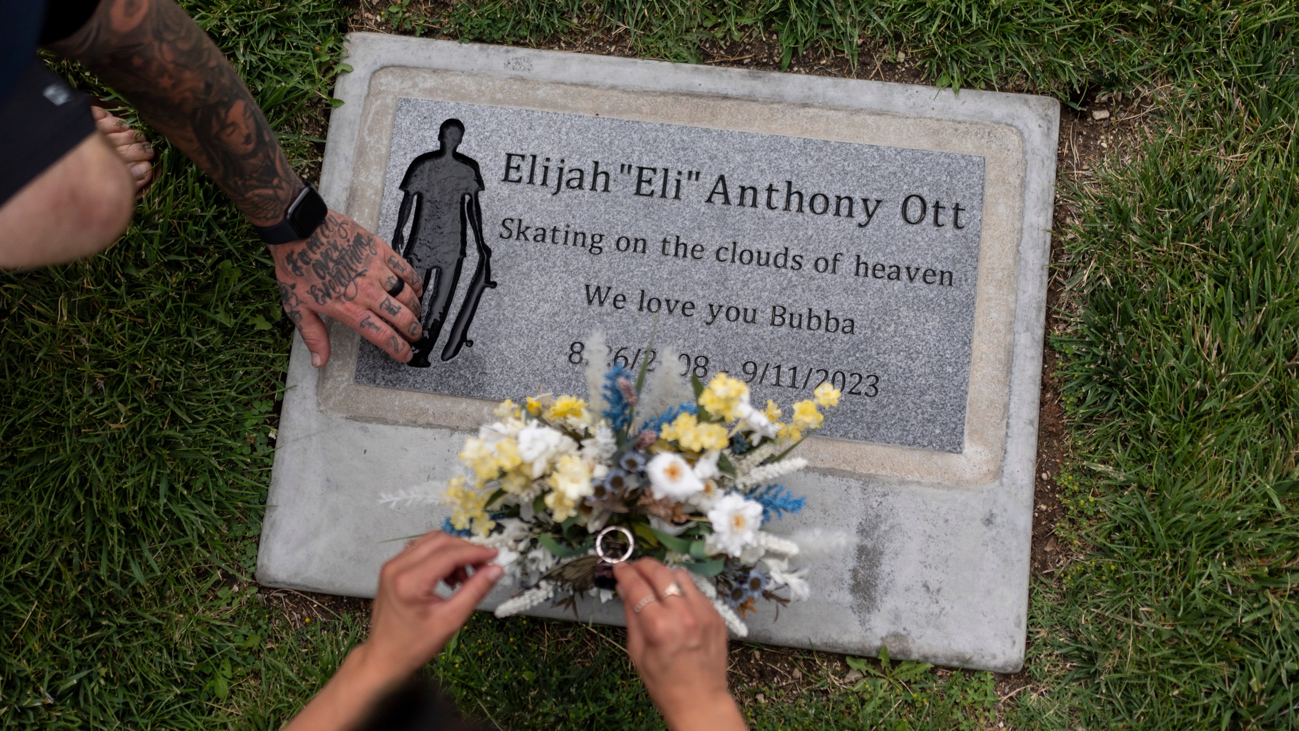 Mikayla Brown and her husband, Tyler, visit the grave of their son, Elijah, who died of a fentanyl overdose at 15, in Paso Robles, Calif., Friday, Aug. 2, 2024. (AP Photo/Jae C. Hong)