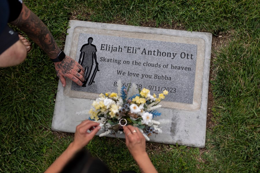 Mikayla Brown and her husband, Tyler, visit the grave of their son, Elijah, who died of a fentanyl overdose at 15, in Paso Robles, Calif., Friday, Aug. 2, 2024. (AP Photo/Jae C. Hong)