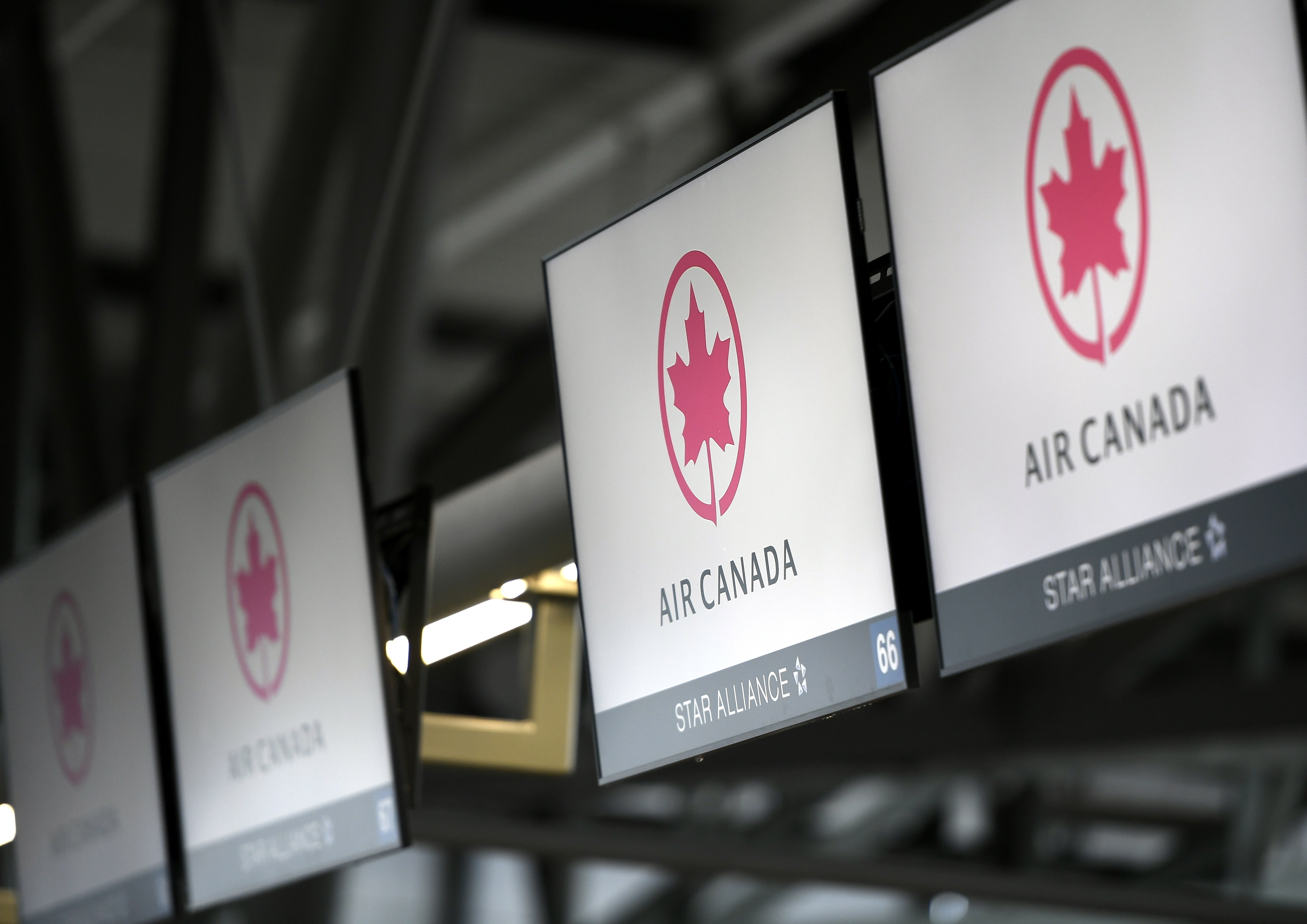 FILE - Air Canada check-in screens are seen at the Ottawa International Airport in Ottawa, Ontario, May 16, 2020. (Justin Tang/The Canadian Press via AP, File)