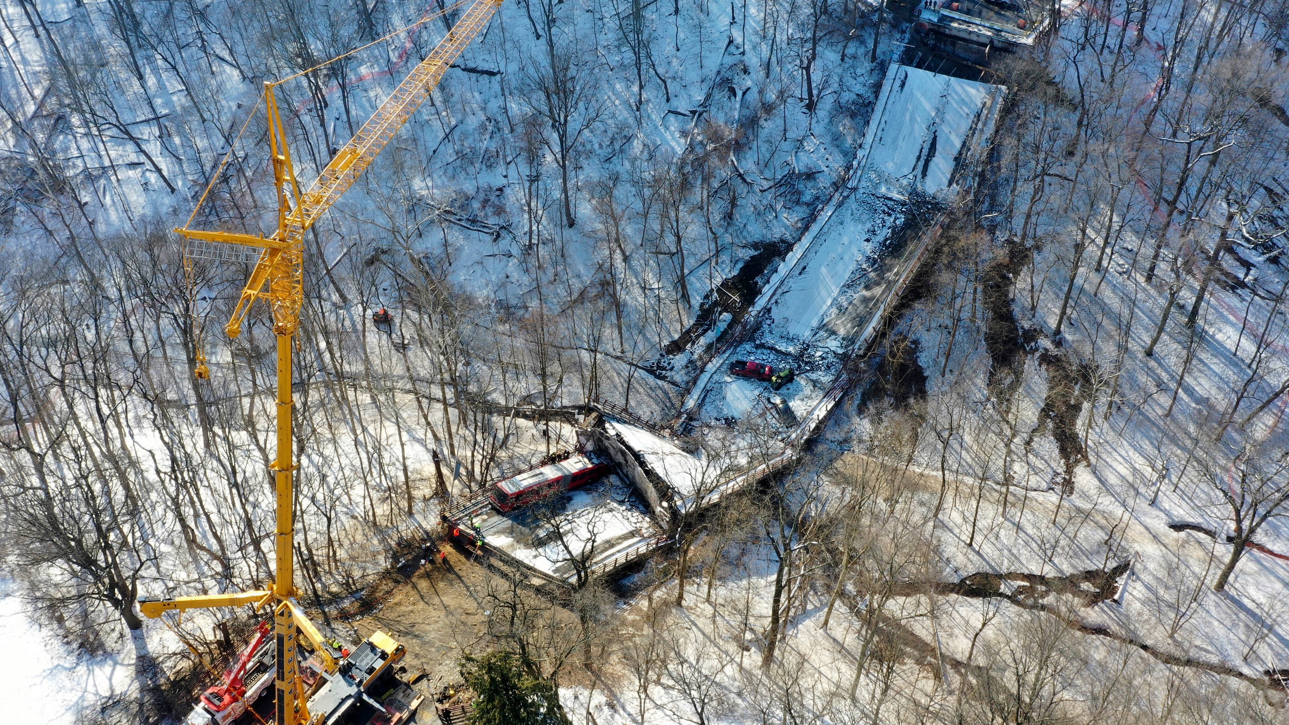 FILE - A crane is in place as part of clean up efforts at the Fern Hollow Bridge in Pittsburgh that collapsed, Jan. 28, 2022. I (AP Photo/Gene J. Puskar, file)