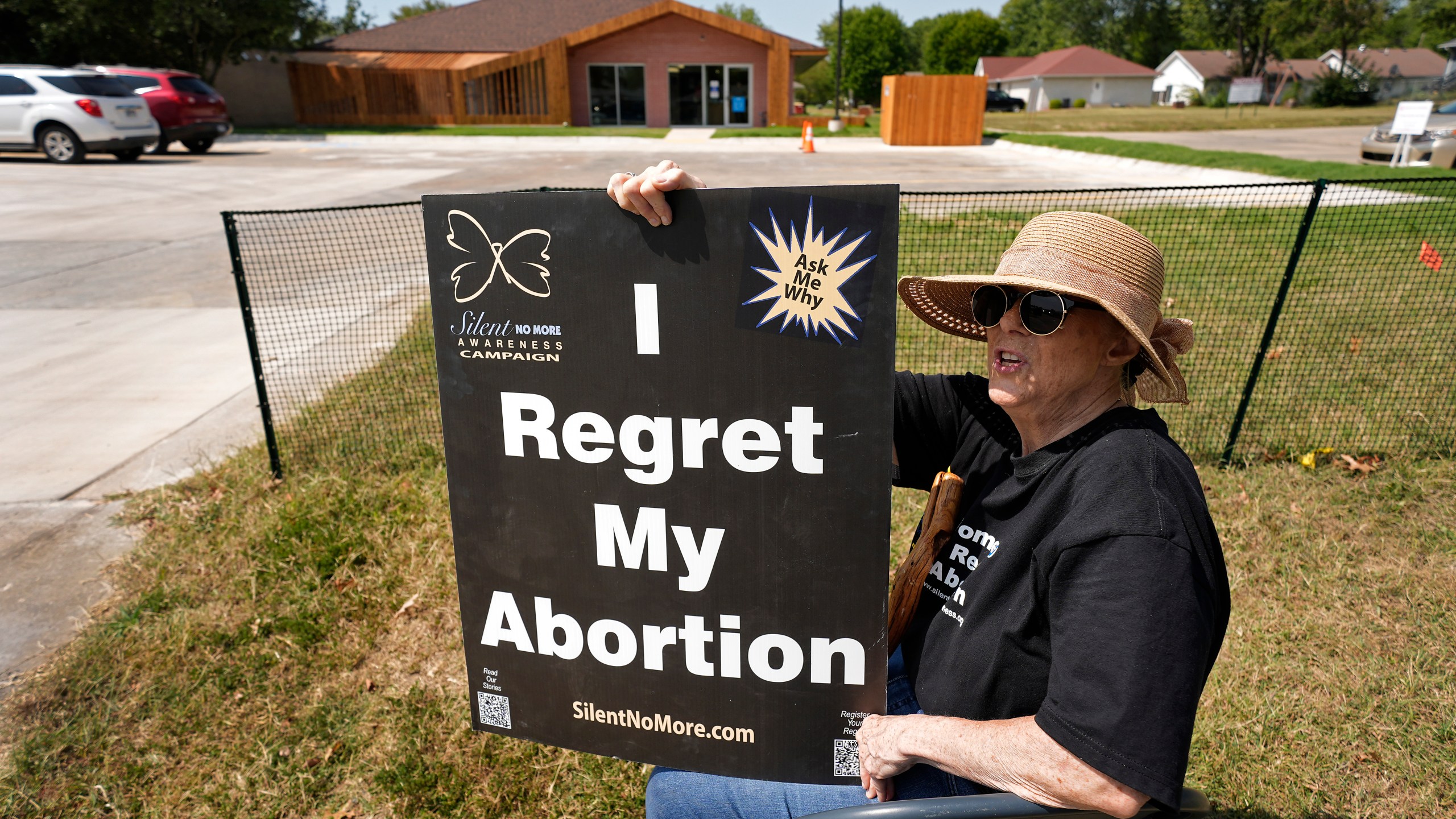 Anti-abortion protester Deborah Green-Myers, from Pittsburg, Kan., demonstrates outside a recently opened Planned Parenthood clinic, Tuesday, Sept. 10, 2024, in Pittsburg, Kan. (AP Photo/Charlie Riedel)