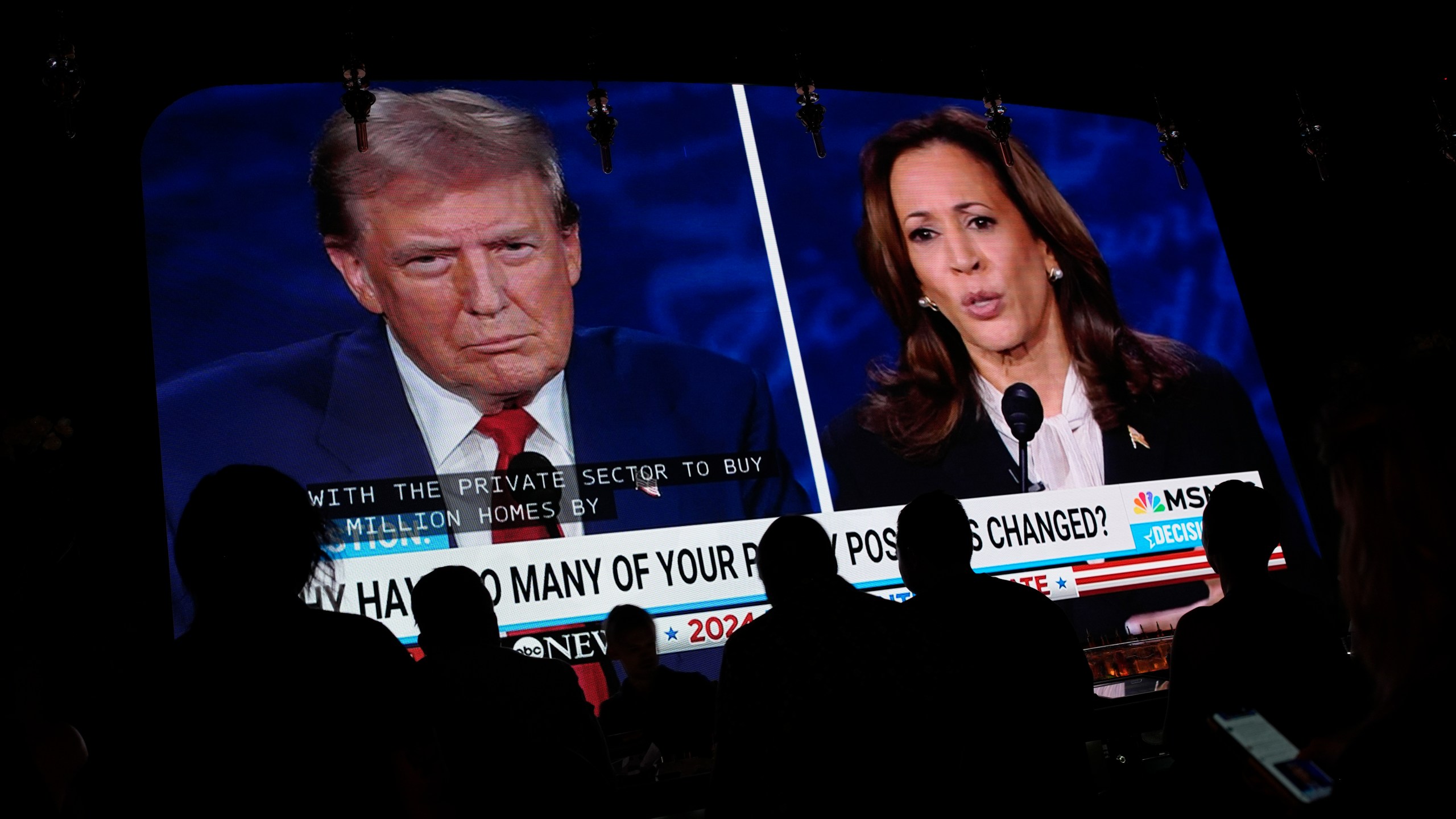 People watch the presidential debate between Republican presidential nominee former President Donald Trump and Democratic presidential nominee Vice President Kamala Harris, Tuesday, Sept. 10, 2024, at the Gipsy Las Vegas in Las Vegas. (AP Photo/John Locher)