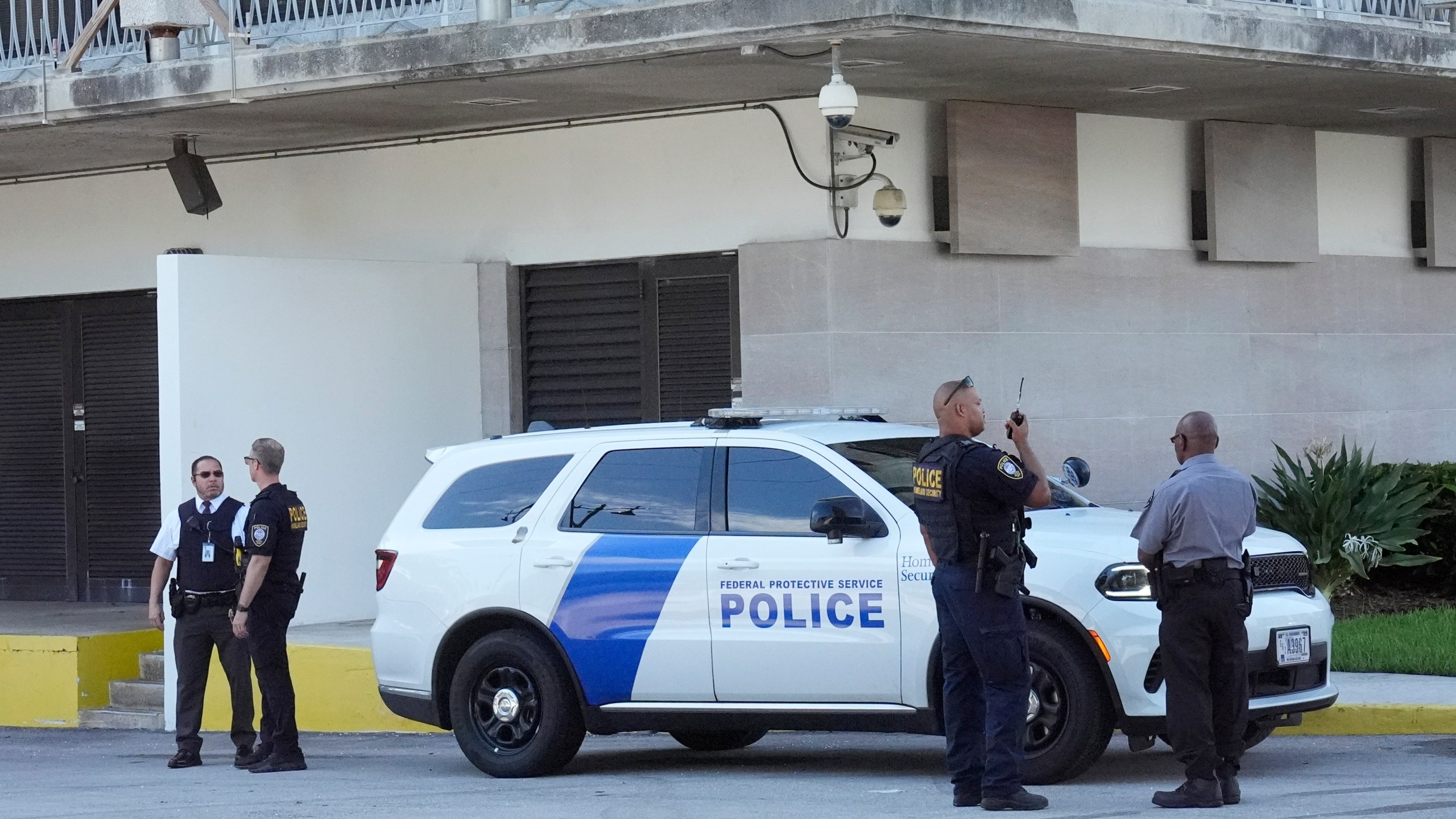 Department of Homeland Security officers patrol outside the Paul G. Rogers Federal Building and U.S. Courthouse, where a man suspected in an apparent assassination attempt targeting former President Donald Trump, was charged with federal gun crimes, Monday, Sept. 16, 2024, in West Palm Beach, Fla. (AP Photo/Wilfredo Lee)