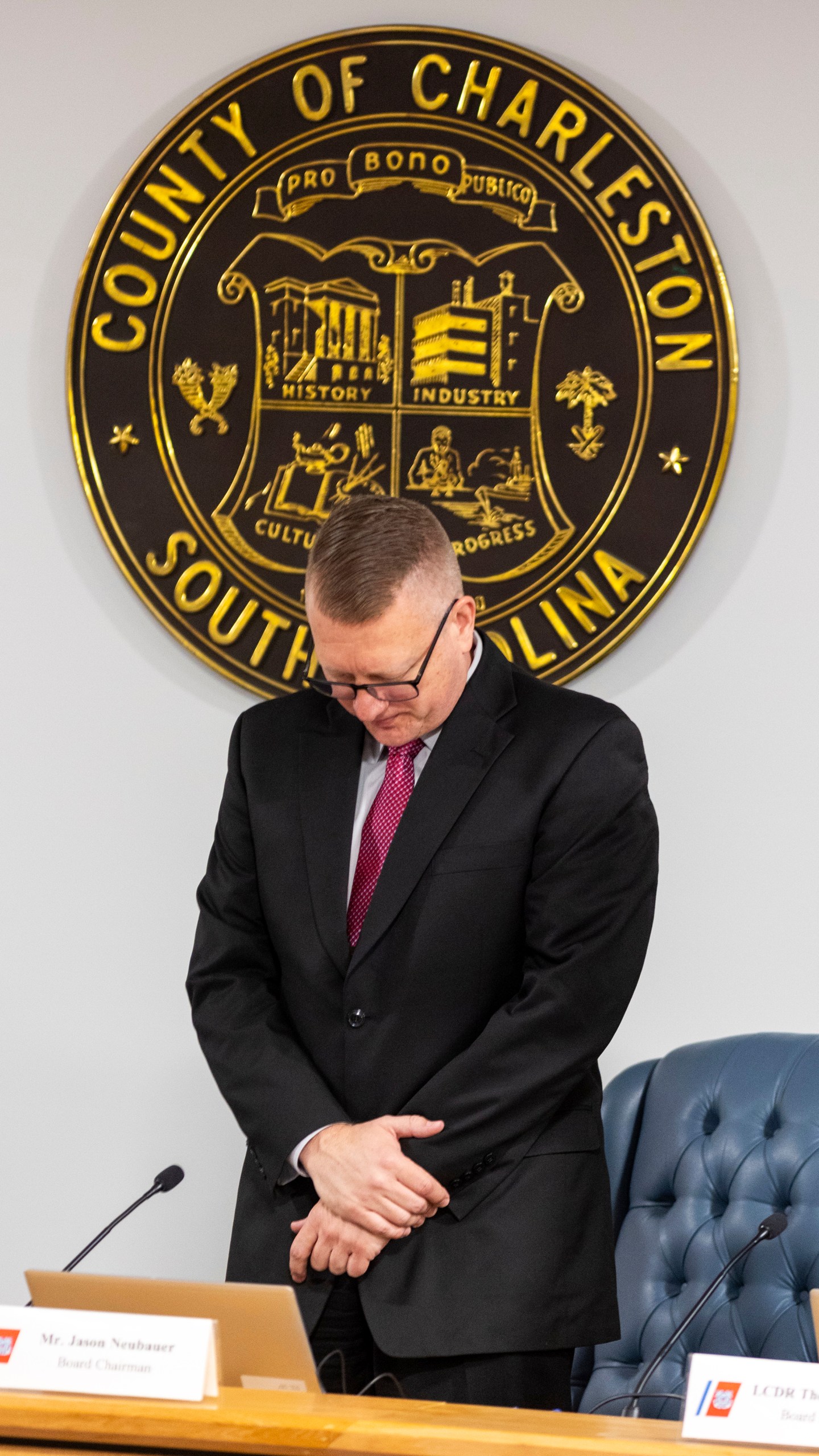 Jason Neubauer, board chairman, of the investigative board for the Titan marine board formal hearing pauses for a moment of silence inside the Charleston County Council Chambers Monday, Sept. 16, 2024, in North Charleston, S.C. (AP Photo/Mic Smith)