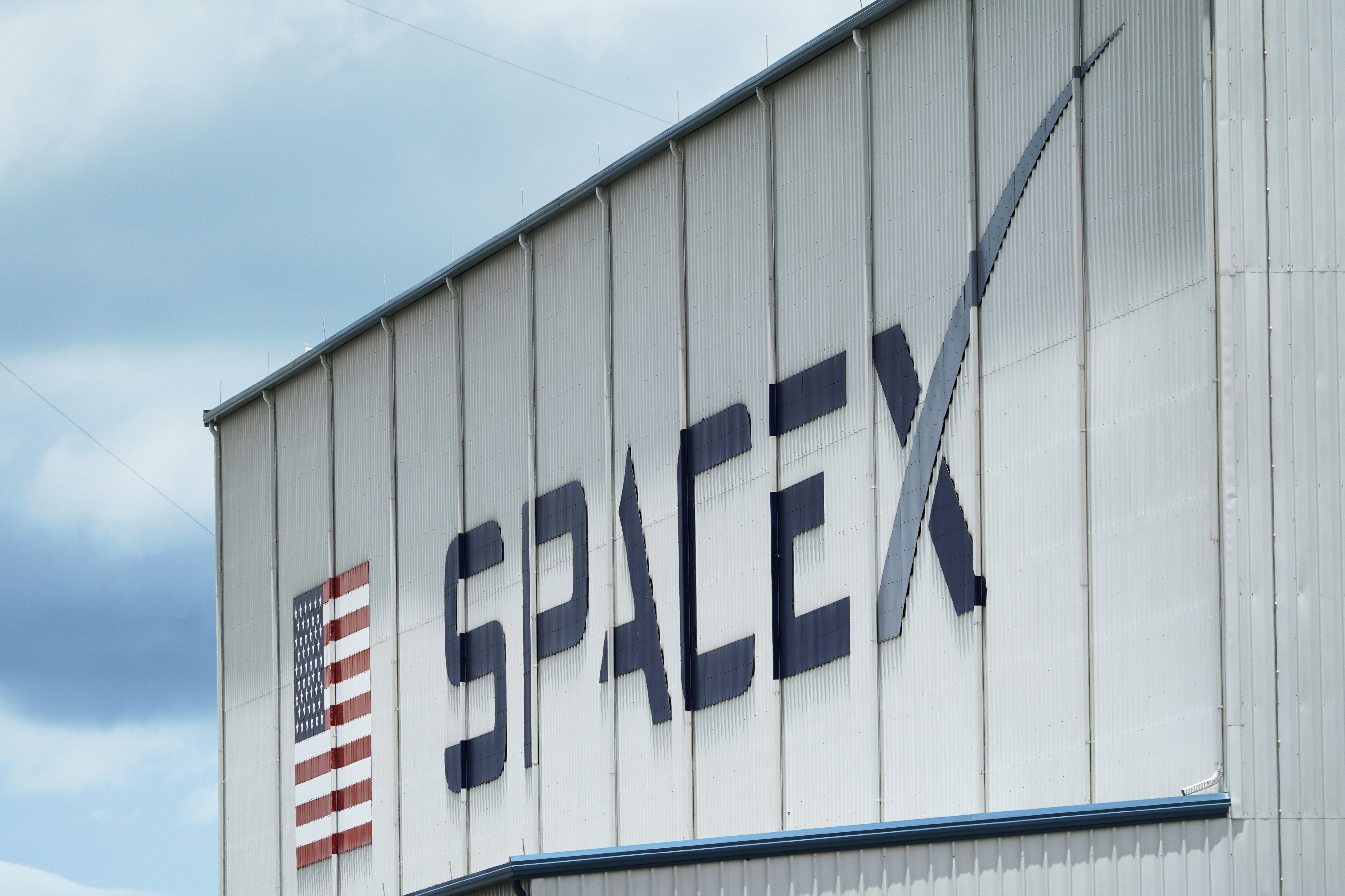 FILE - The SpaceX logo is displayed on a building, Tuesday, May 26, 2020, at the Kennedy Space Center in Cape Canaveral, Fla. (AP Photo/David J. Phillip, File)