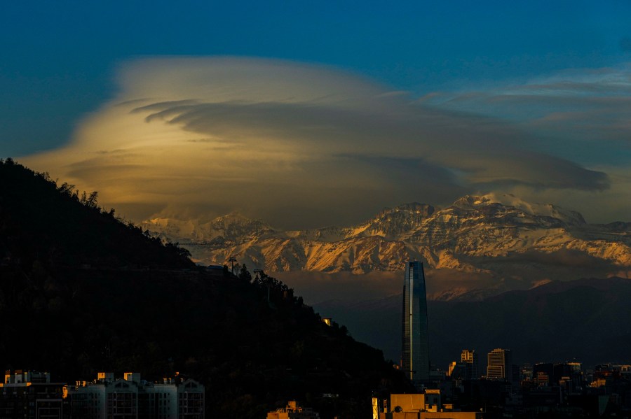 FILE - Clouds hover over the Andes Mountains in Santiago, Chile, June 19, 2024. (AP Photo/Esteban Felix, File)