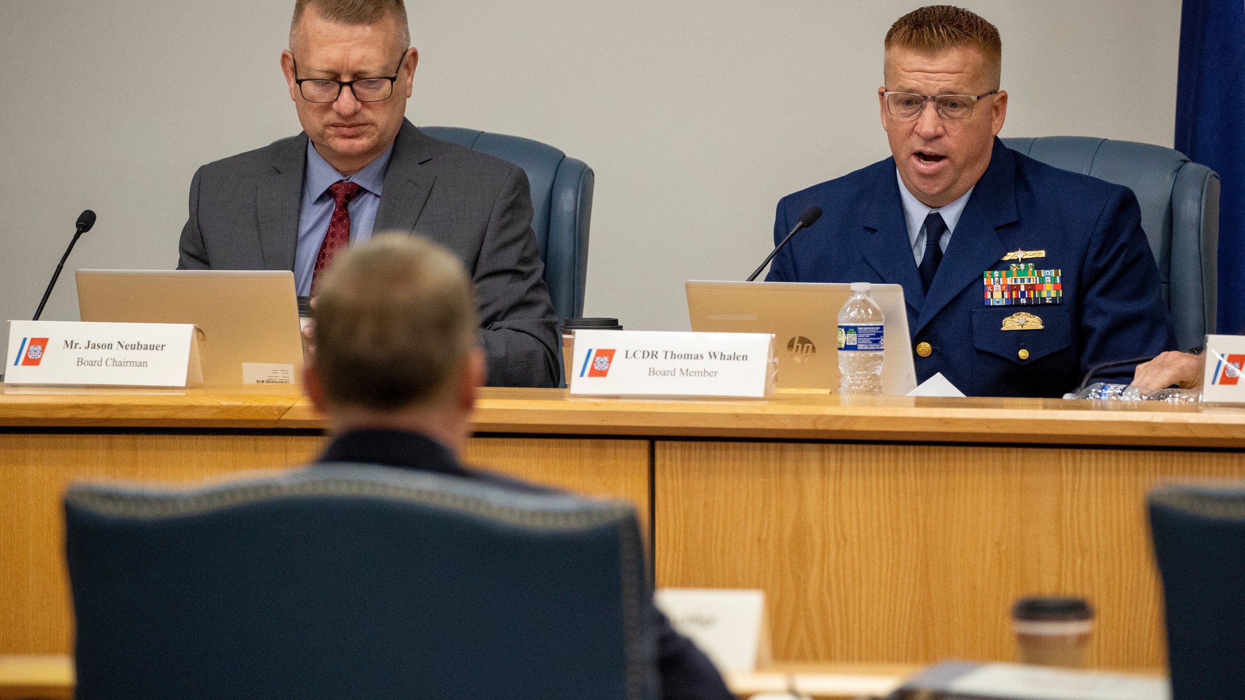 Board Chairman Jason Neubauer, left, and board member Thomas Whalen, of the investigative board for the Titan marine board formal hearing, speak with former OceanGate's Director of Marine Operations David Lochridge, foreground, Tuesday, Sept. 17, 2024, in North Charleston, S.C. (Andrew J. Whitaker/The Post And Courier via AP, Pool)